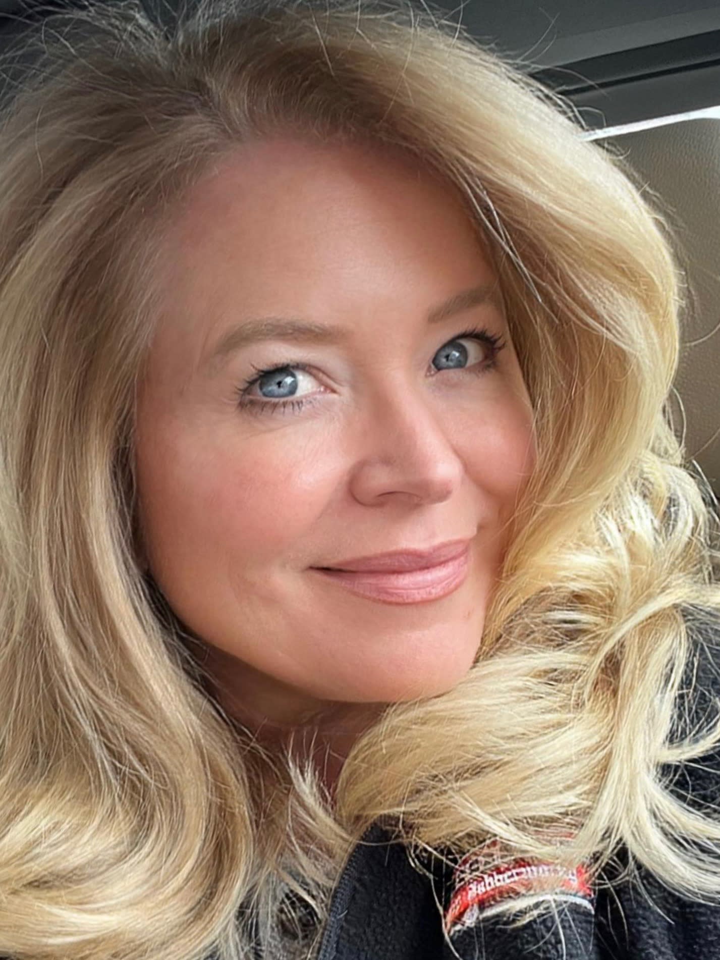 Headshot of Lauren Beckham Falcone, a white woman with wavy, shoulder-length blonde hair, blue eyes, and an engaging smile.