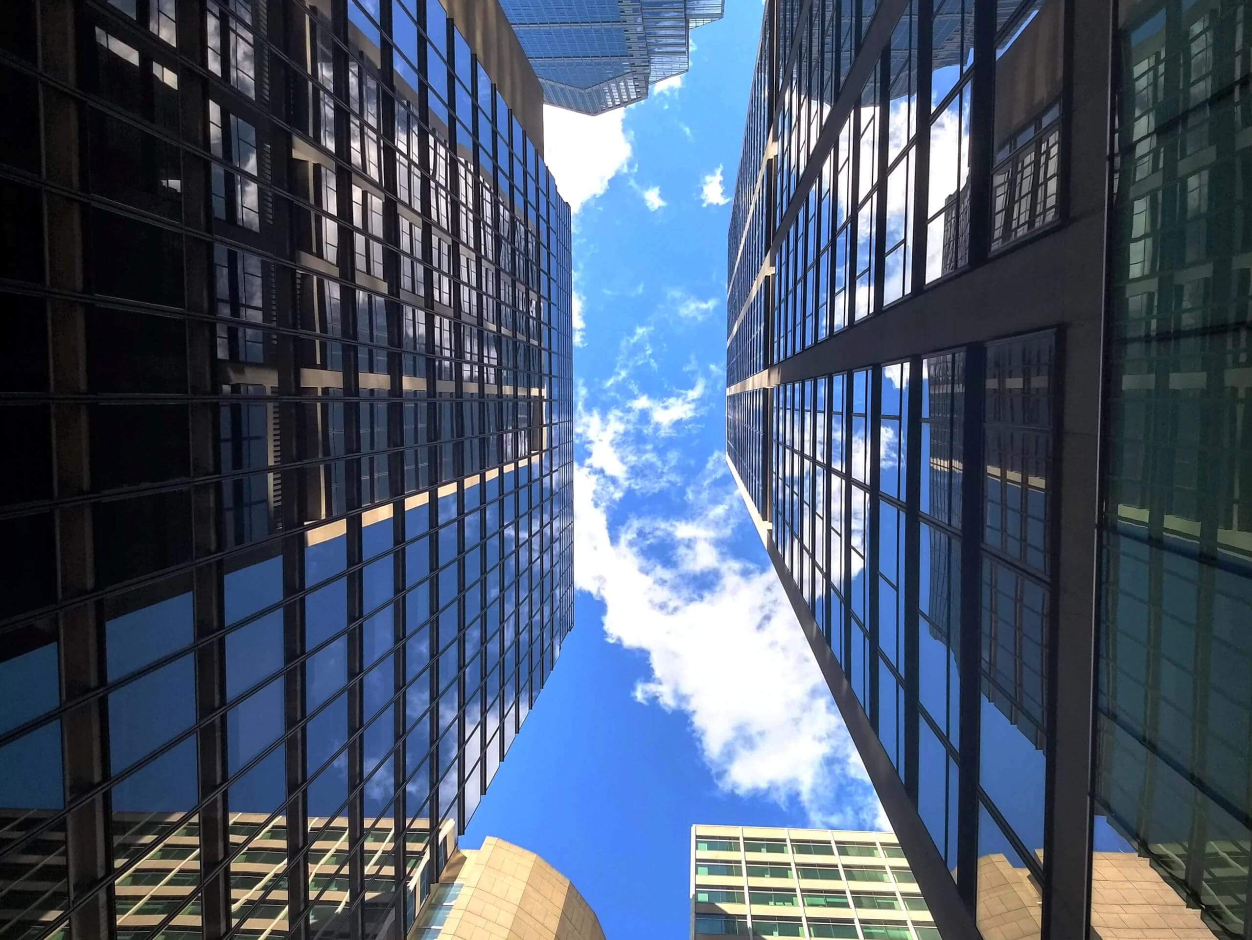 A view of the sky between two reflective buildings in Center City, Philadelphia