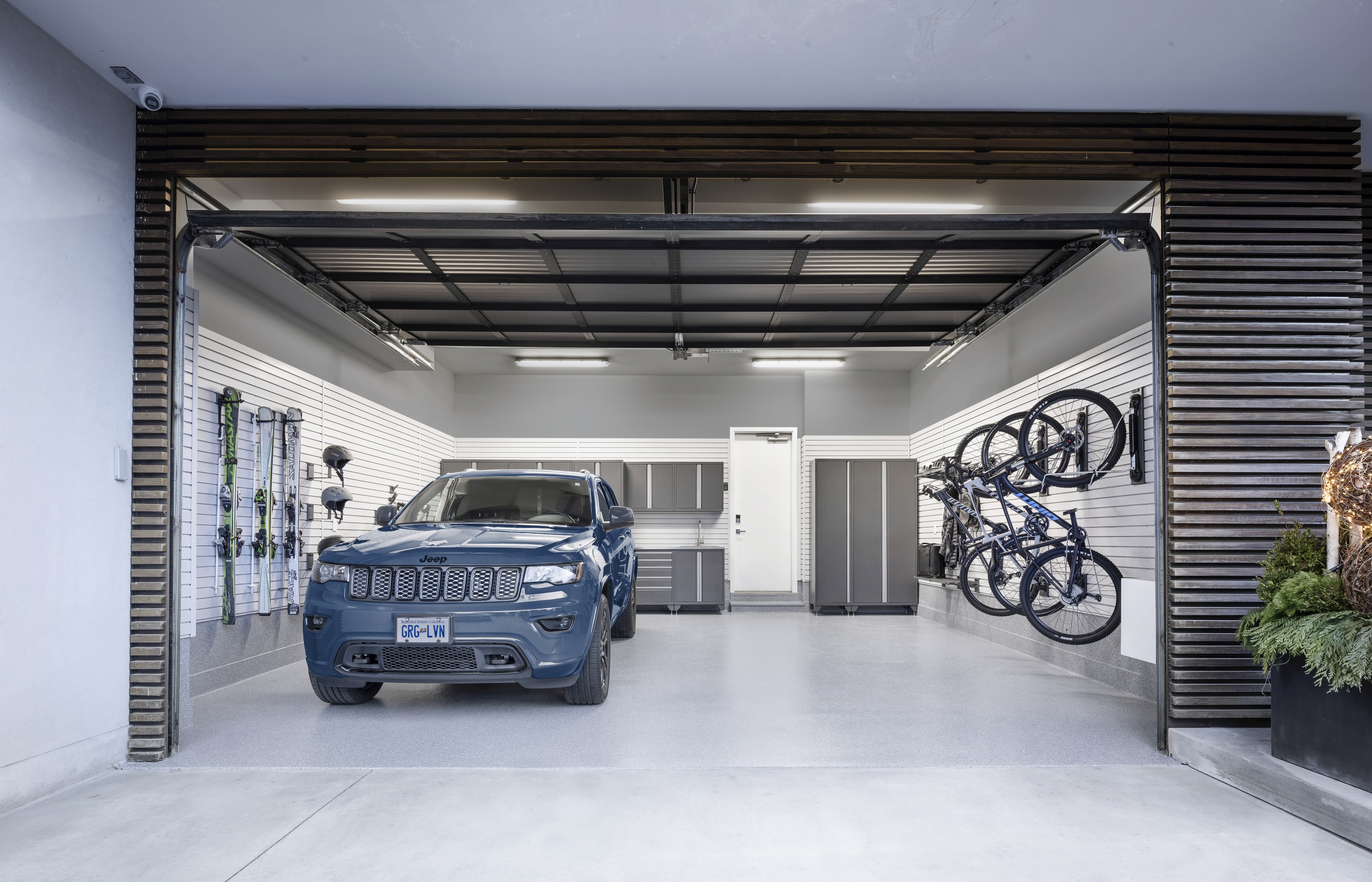 Garage Living Vancouver garage transformation in 2-car garage with floor coating, cabinets, slatwall, vertical bike racks