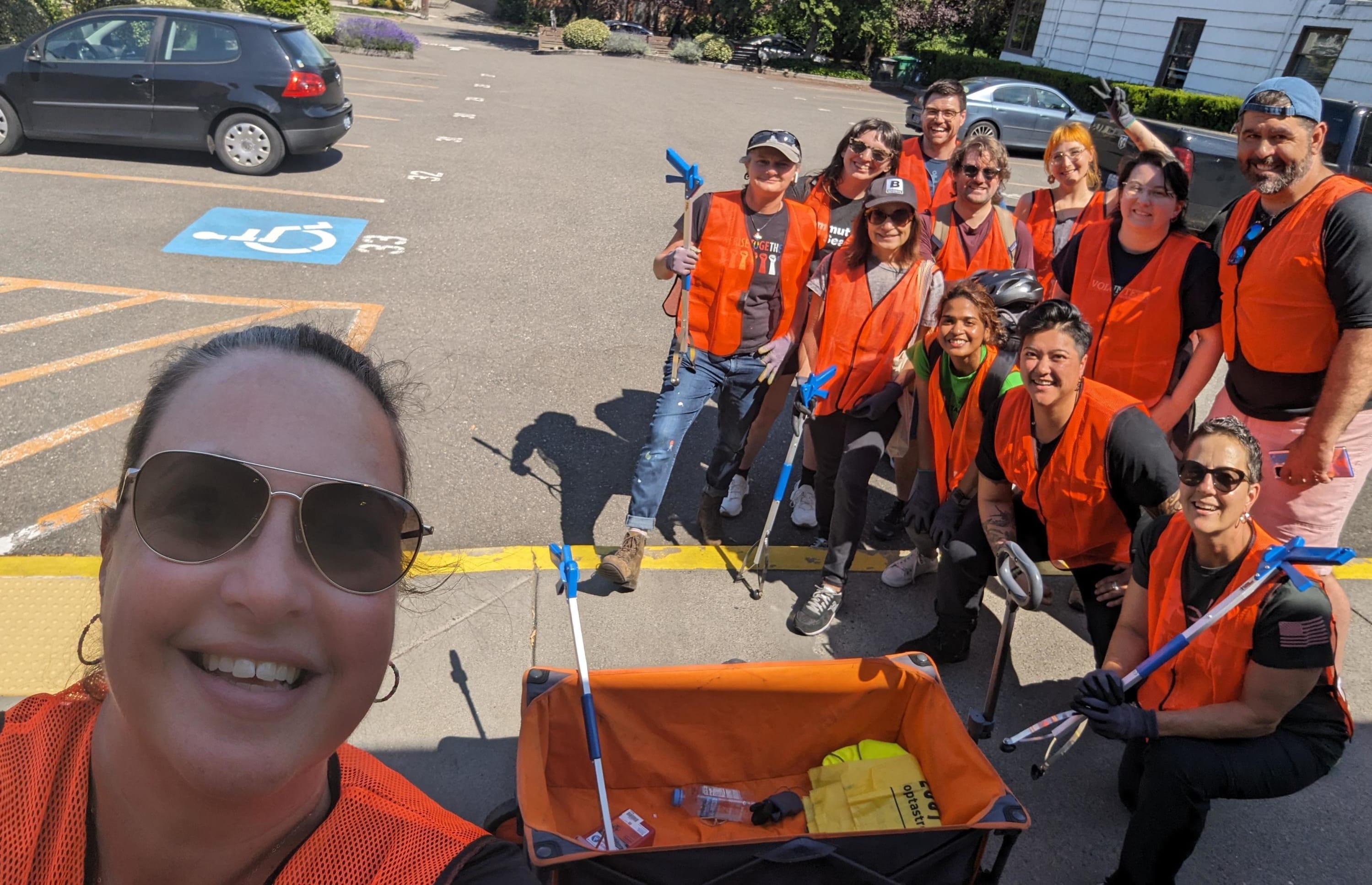 Individuals in orange vests in a parking lot