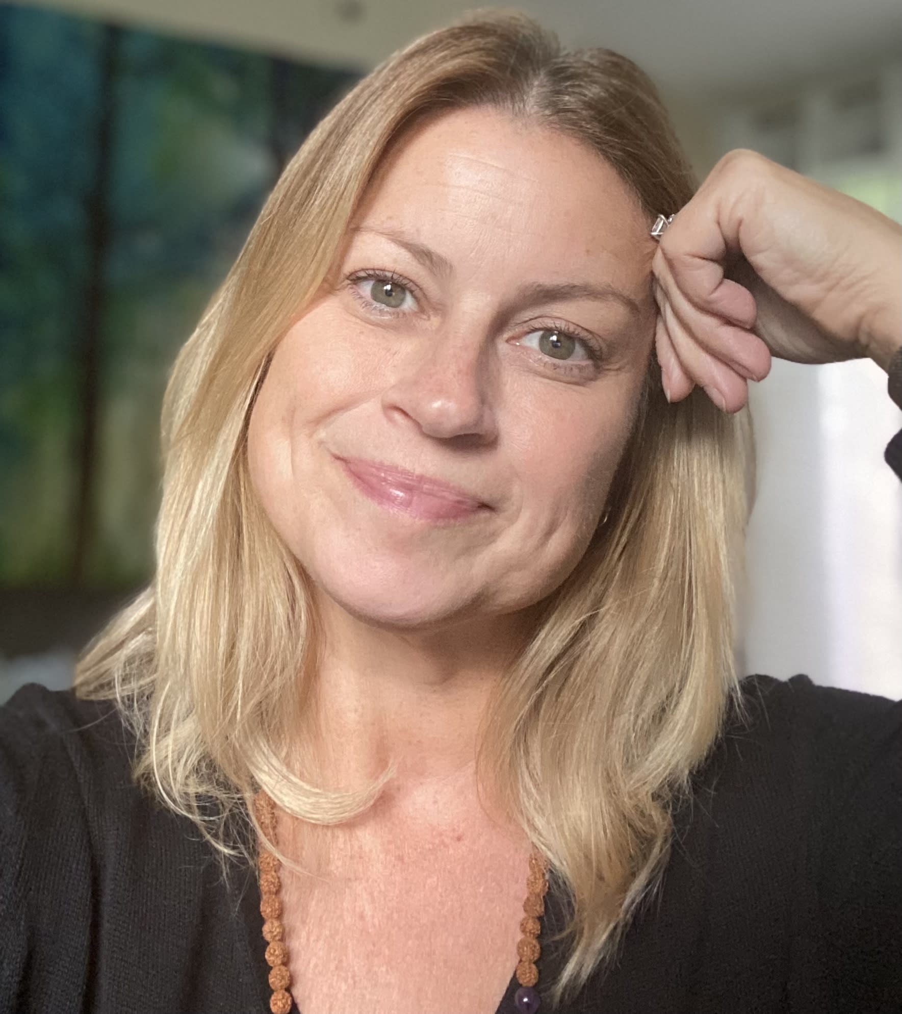 picture of Jenn Hoffman, LCSW at Instar Healing. Blonde hair and green eyes leaning on her hand