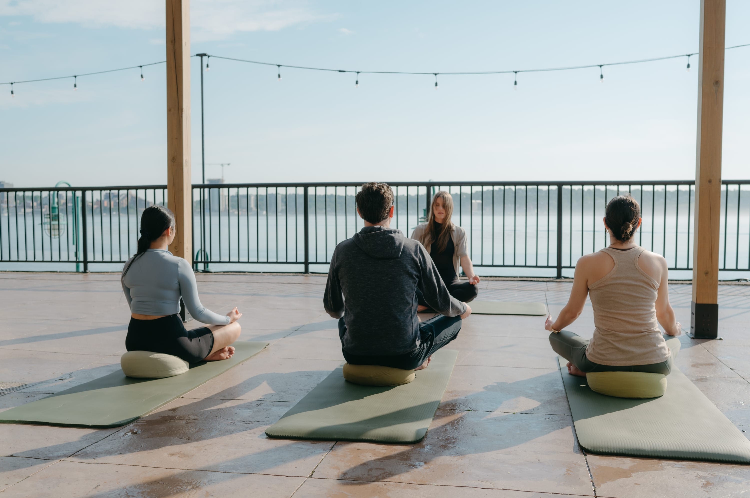 Guests enjoying an early morning meditation on Sable Patio at the Halifax Marriott Harbourfront, overlooking the harbour