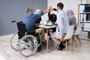 Disabled businessman and team