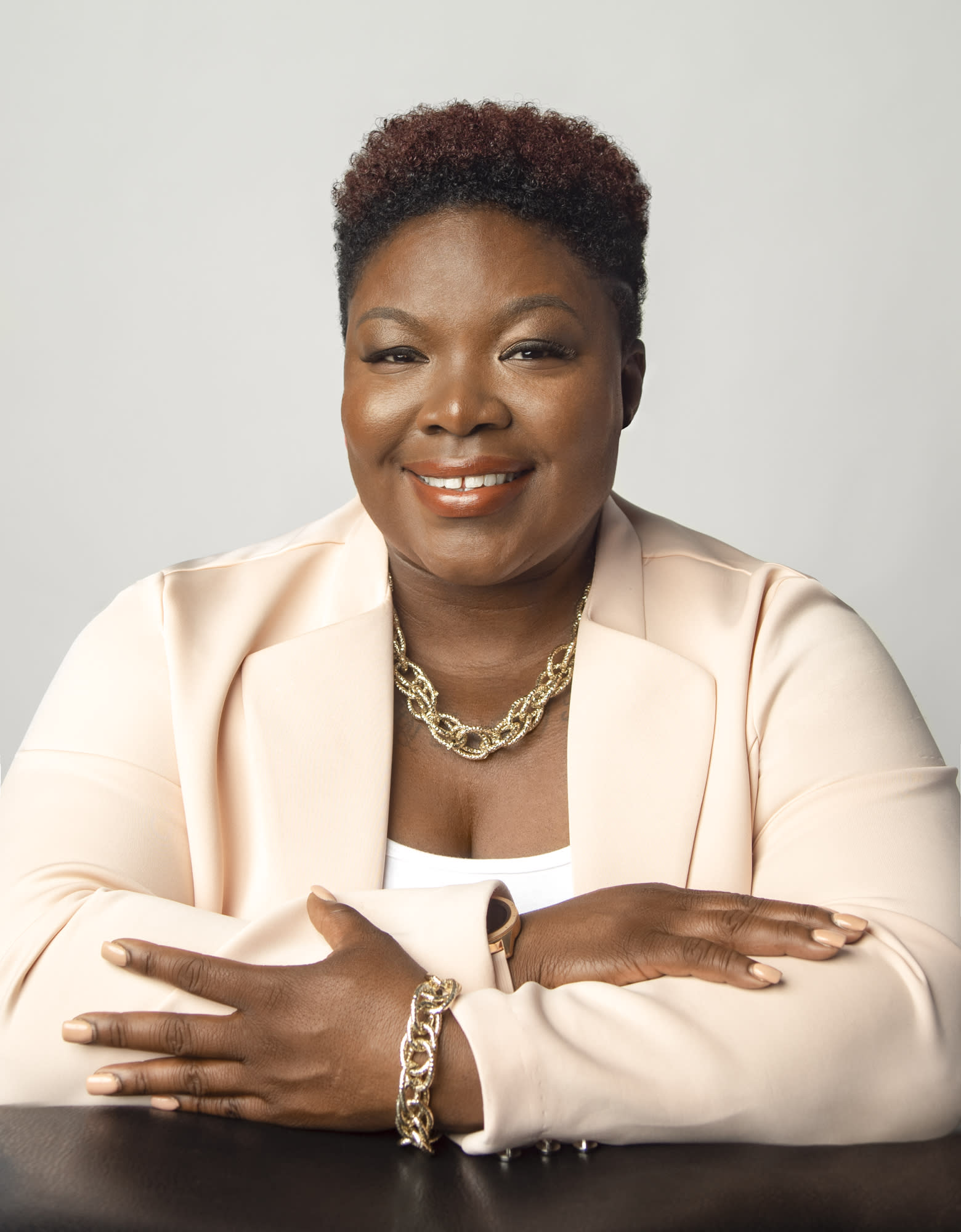 black woman posing with folded arms