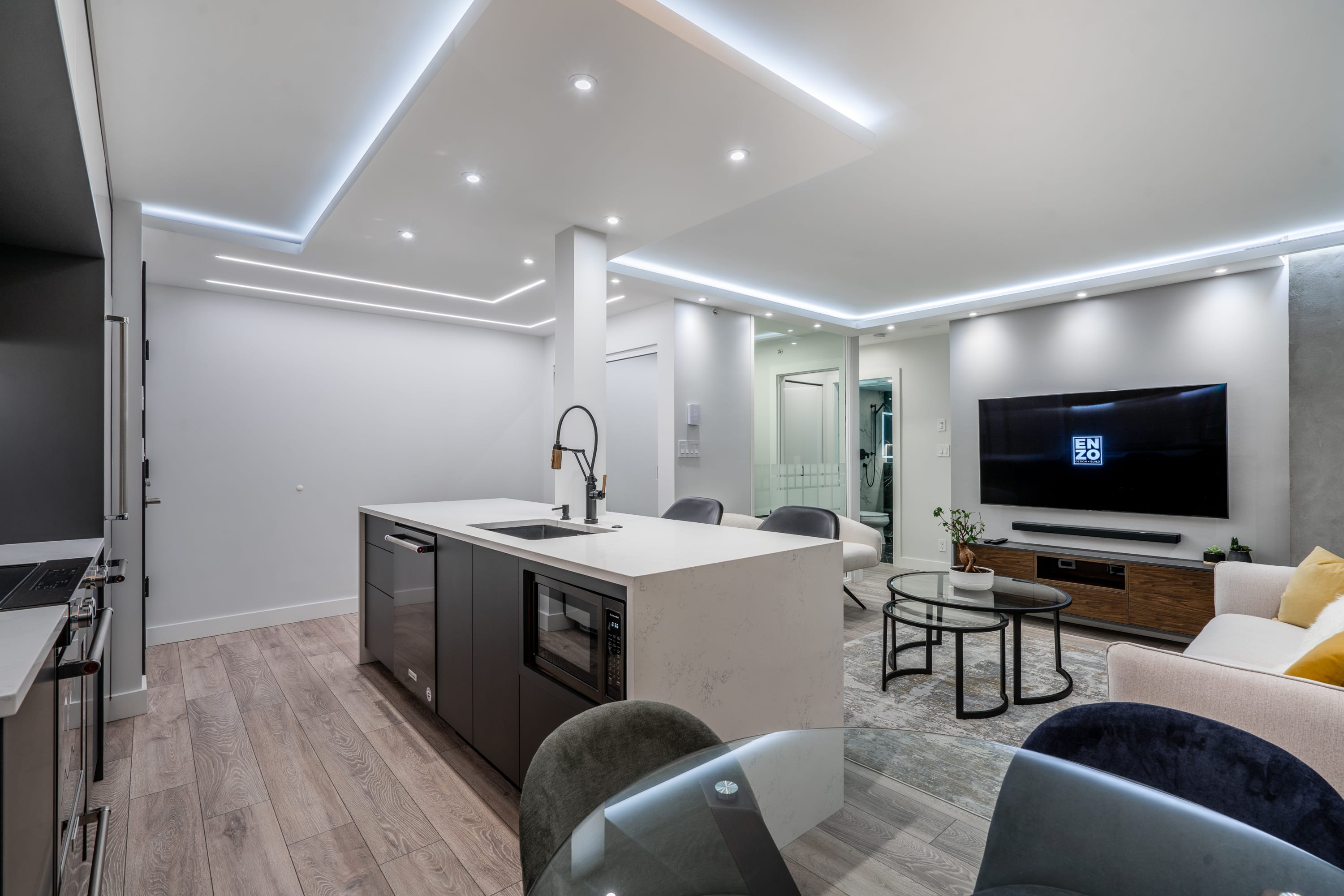 open-concept-kitchen-ceiling-light-design-black-gold-faucet-built-in-microwave-dishwasher-