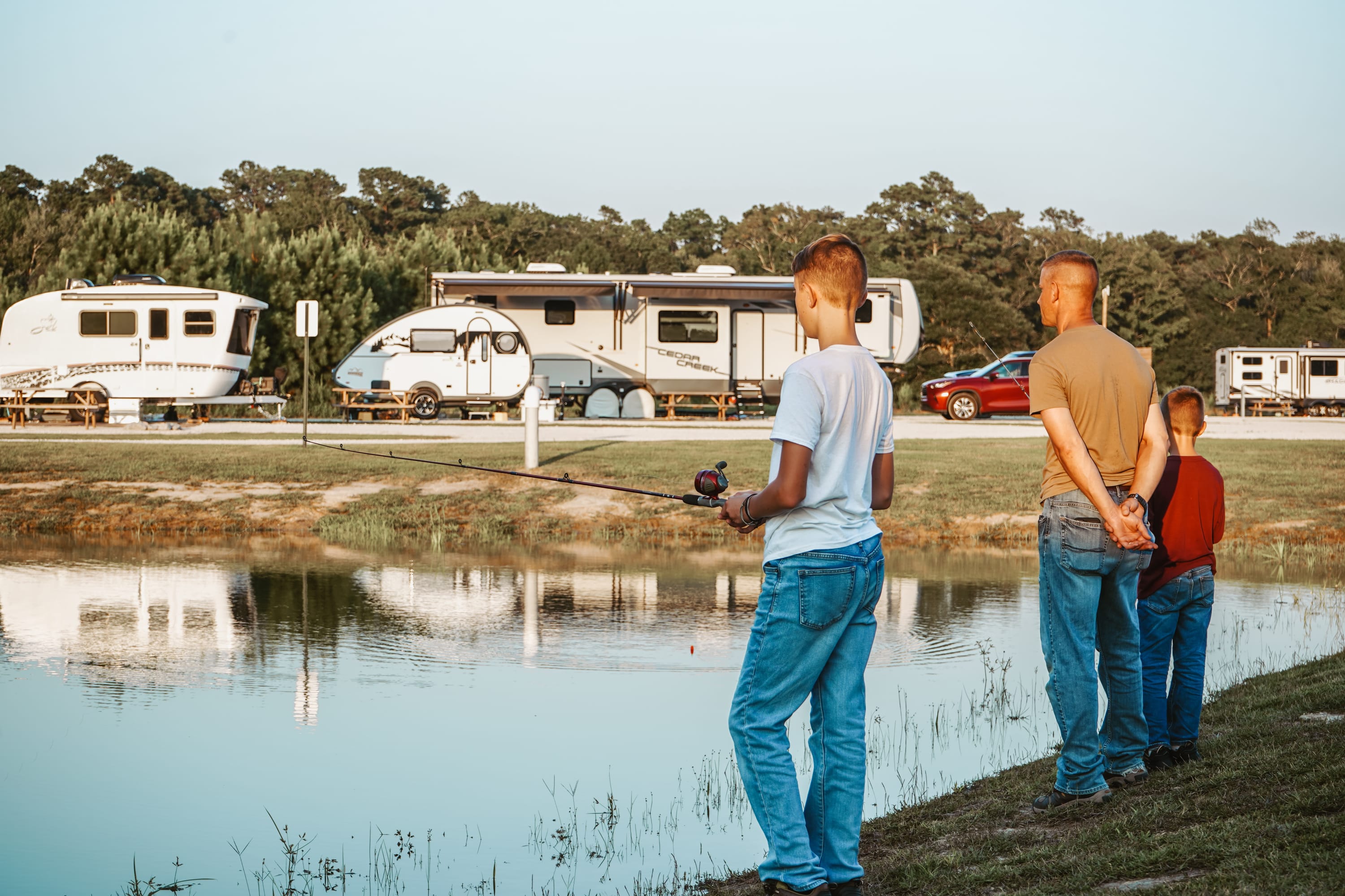 Dad and his 2 boys enjoying fishing at Dogwood Family Campground