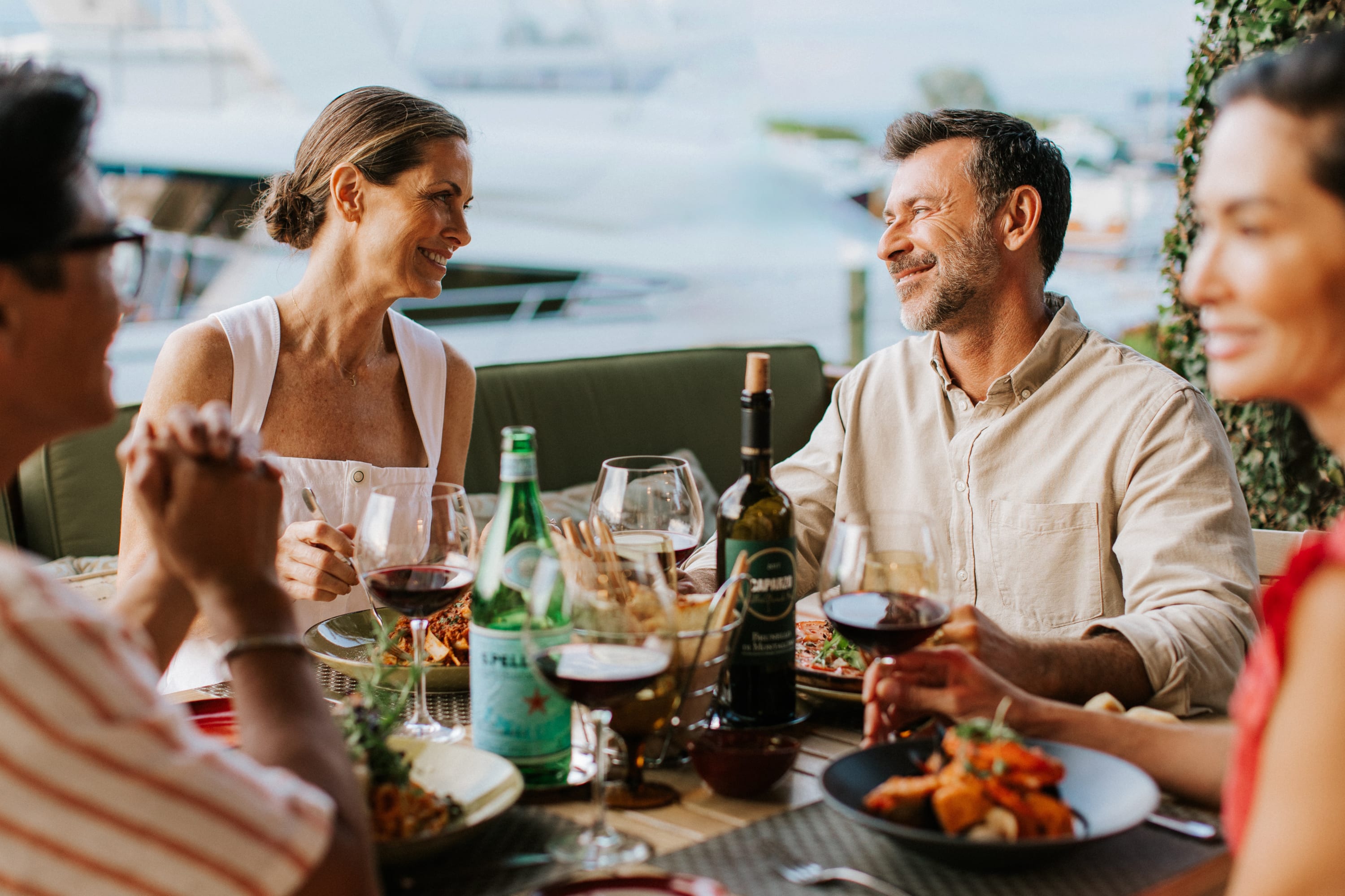 two couples dining at the marina
