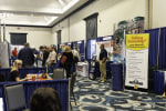 2025 CARVC conference trade show people walking in aisle meeting vendors.