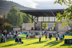 Community picnic guests on the upper field in front of the Avon Pavilion stage