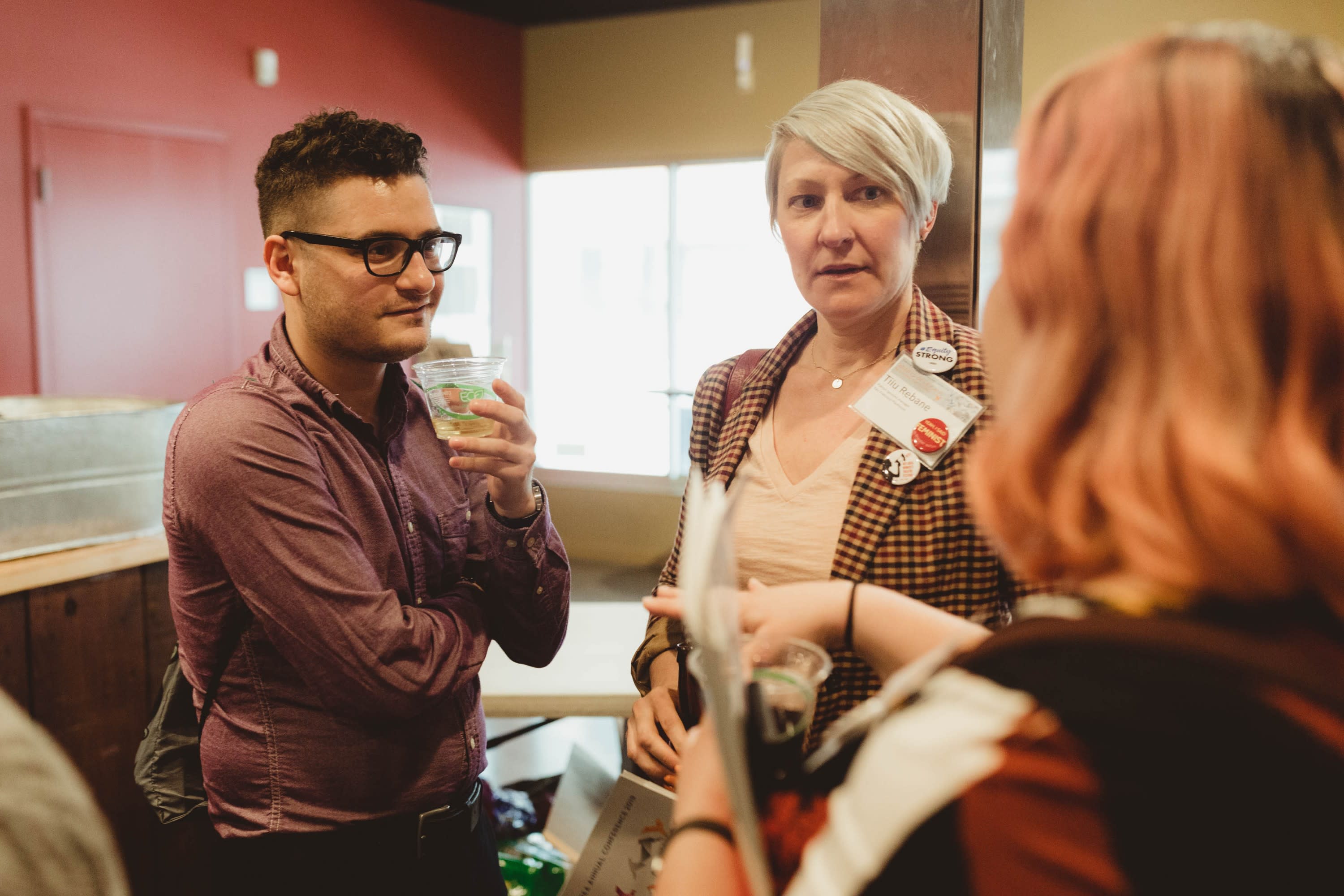 A group of attendees engage in conversation.