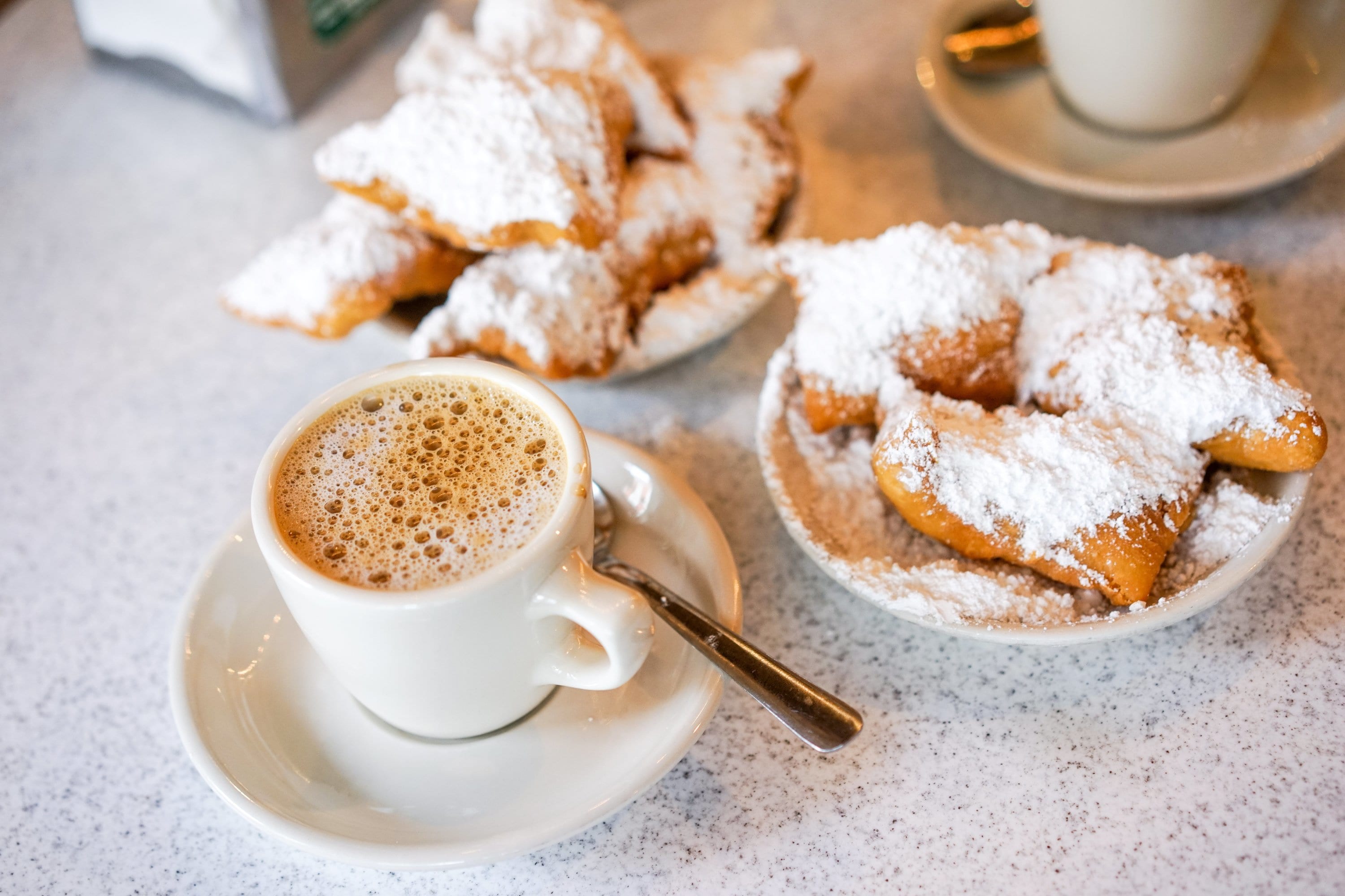 Historic New Orleans' Caf‌é Du Monde picture showing Caf‌é au Lait and beignets