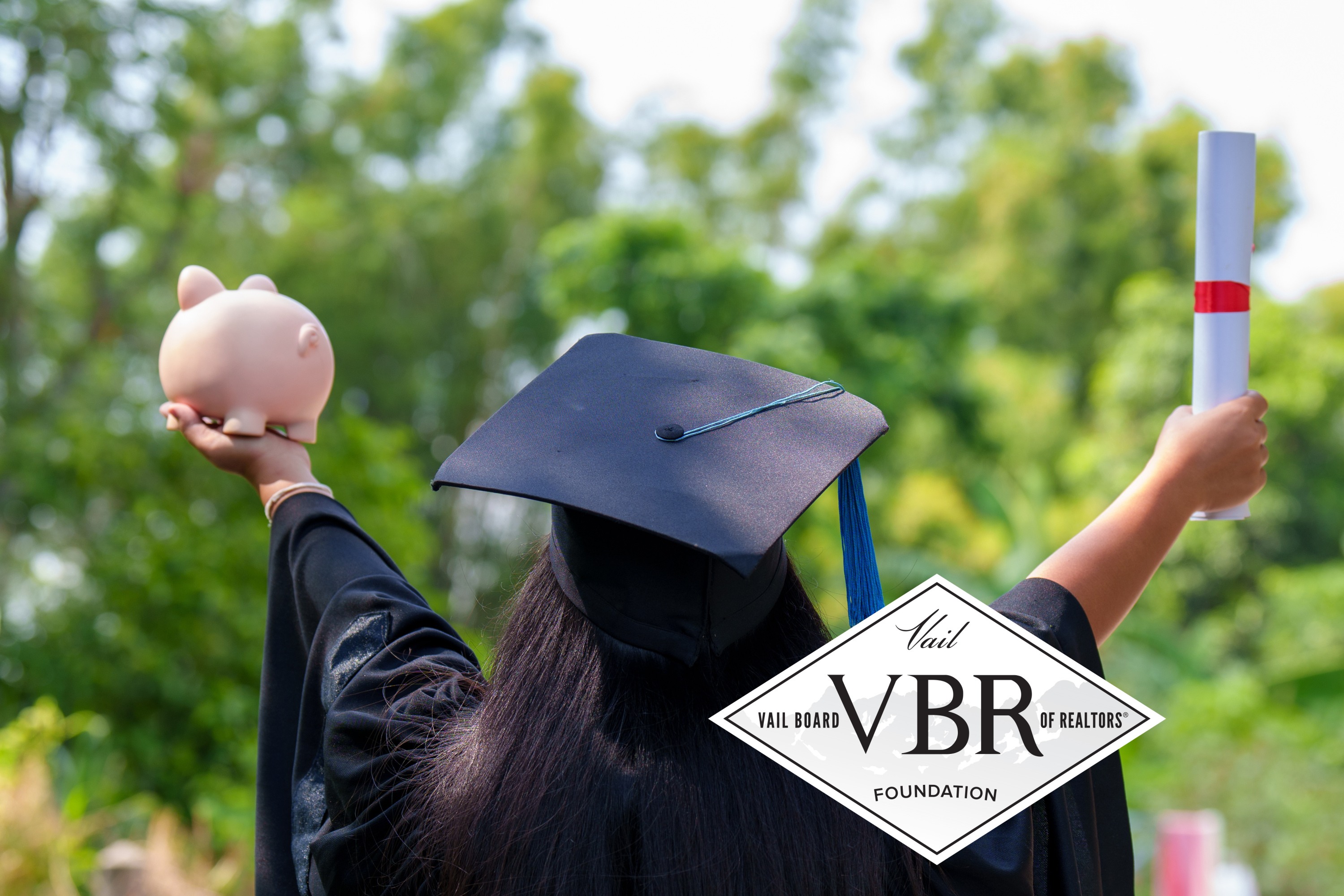 Graduate with diploma piggy bank & VBR Foundation logo