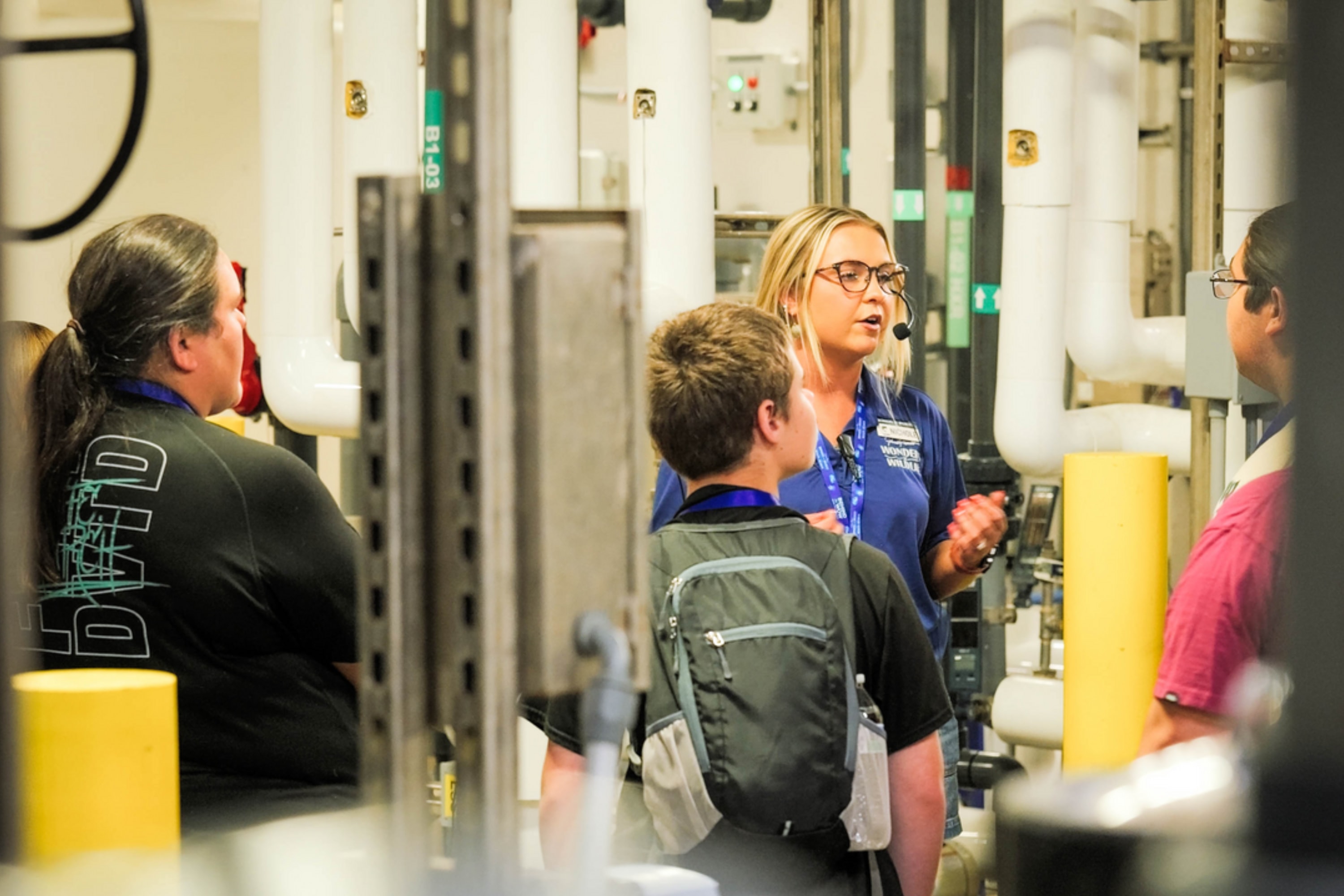 Educator talking to three guests one a behind the scenes tours