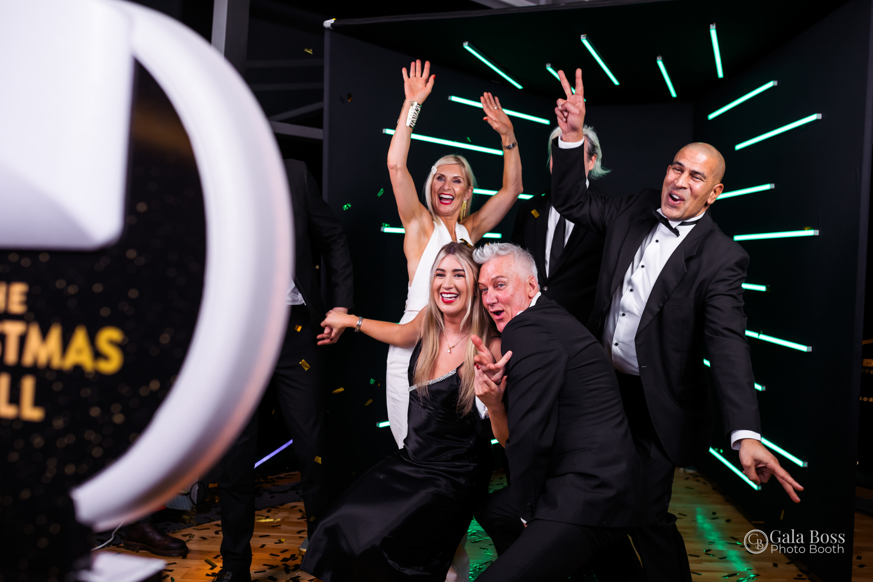 Guests celebrating and posing at a Gala Boss interactive photo booth during a corporate event