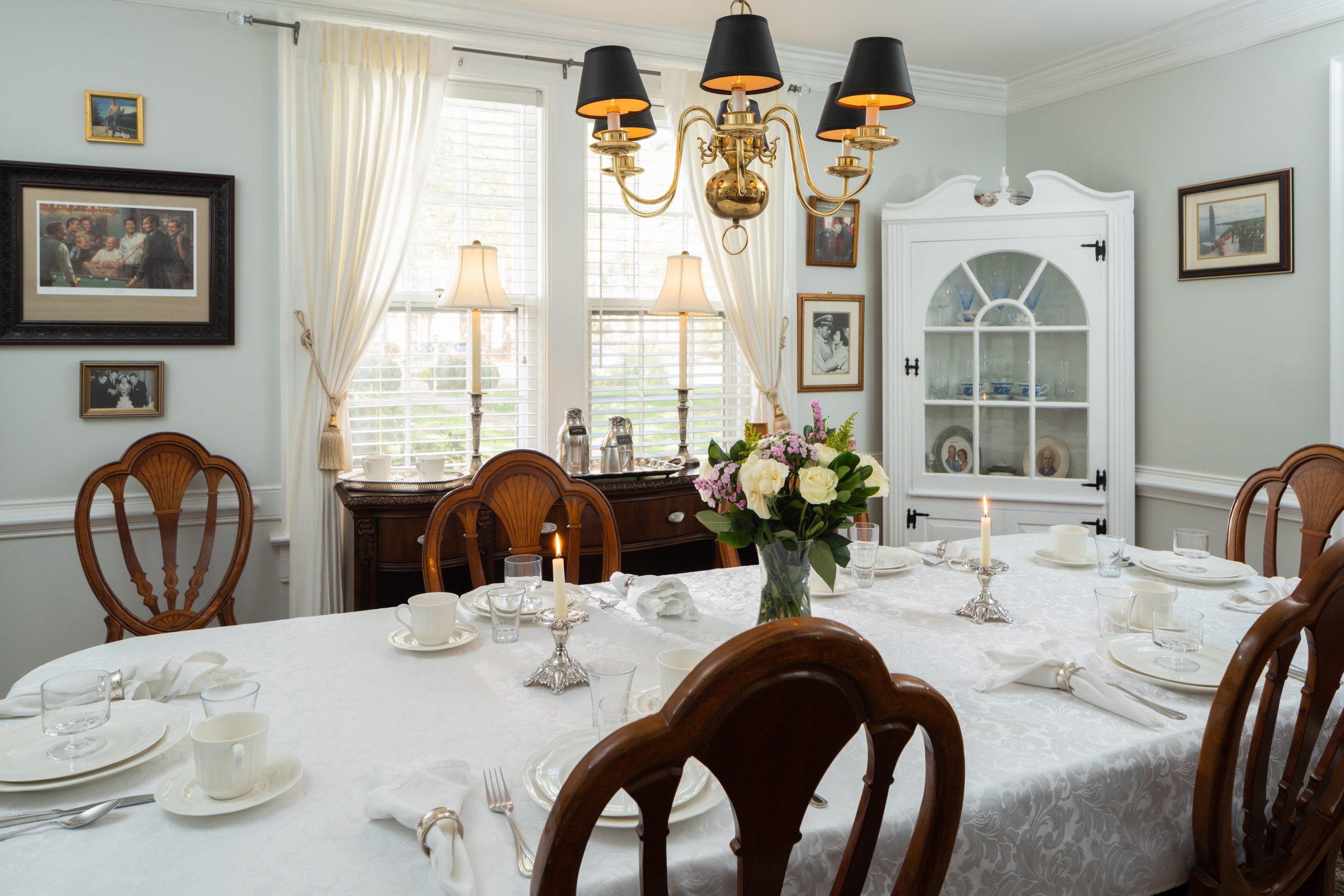 White tablecloth on Dining Room table, sunlight through windows