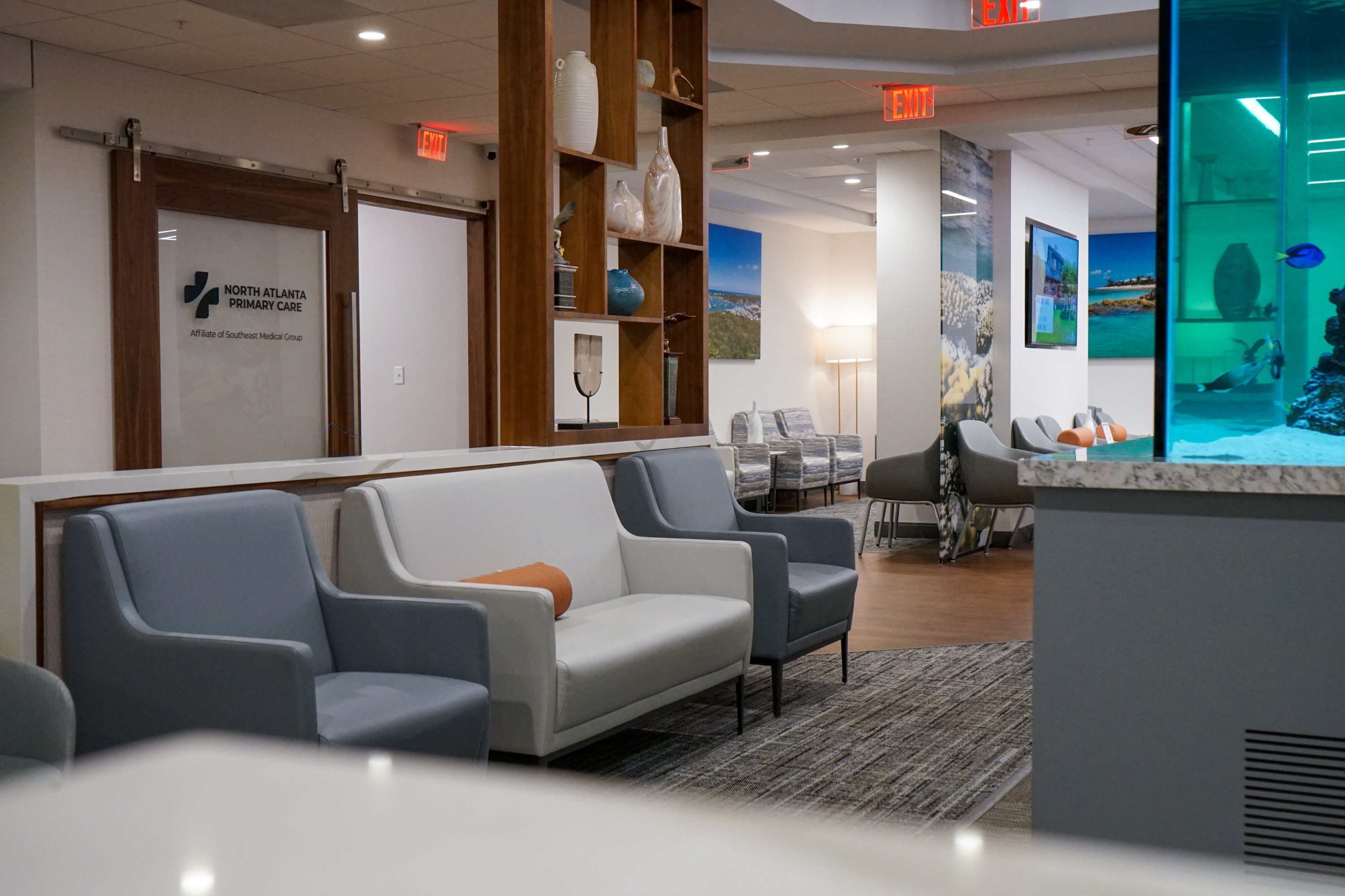 North Atlanta Primary Care Alpharetta clinic waiting room with a bright blue fish tank and many comfortable seats.