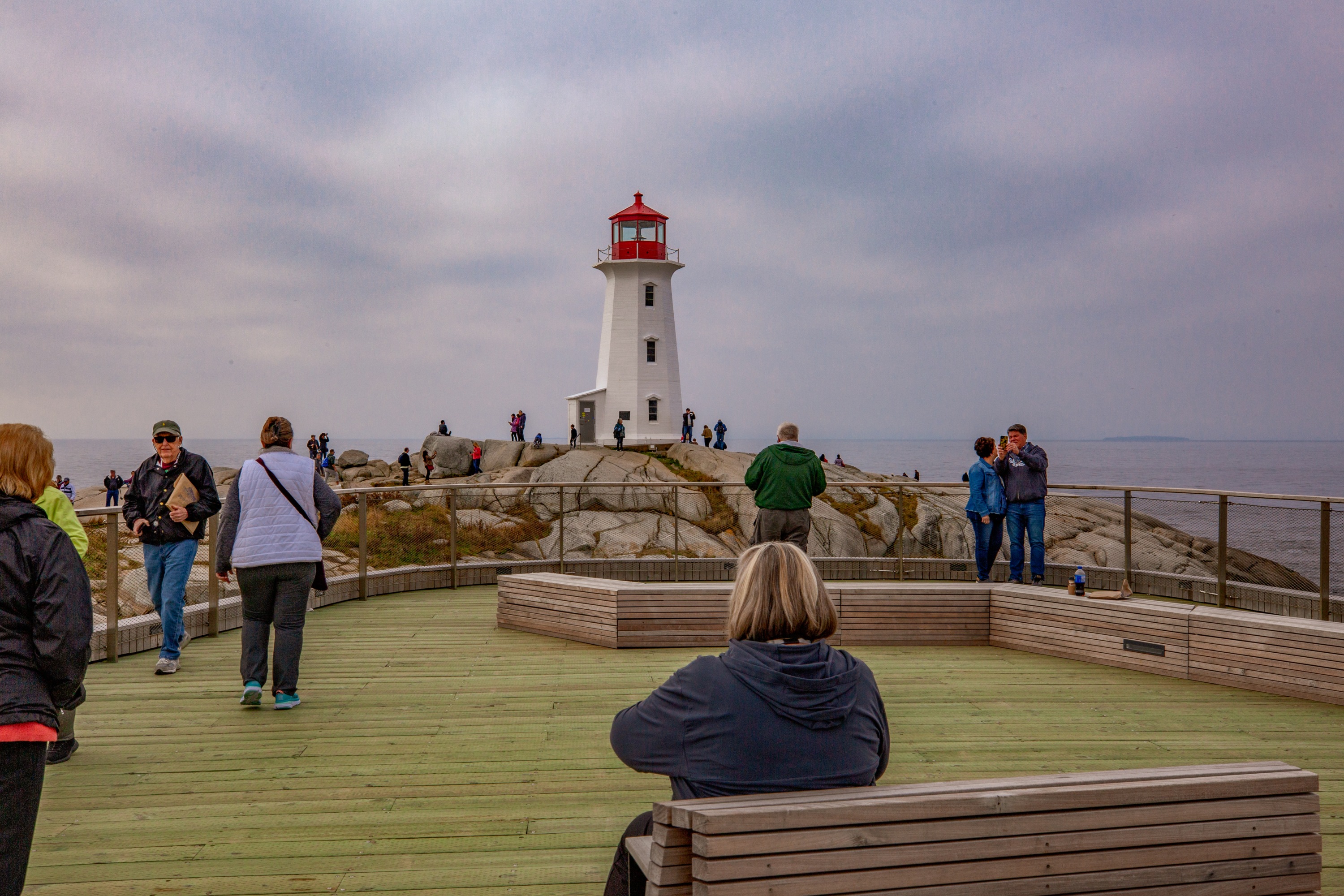 Folks take photos and selfies on the viewing deck at Peggy's Cove