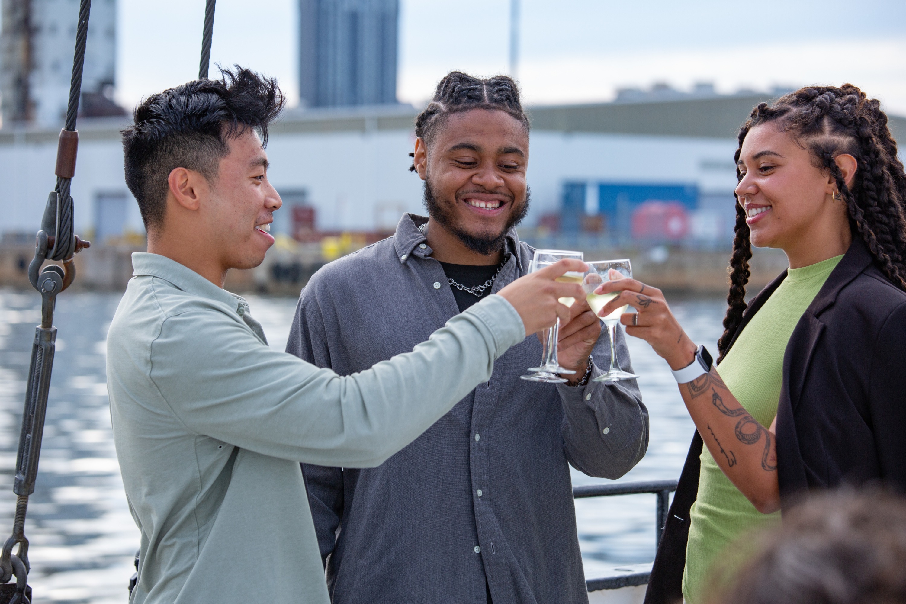 Three friends raise a toast on the Wines on the Water tour on Tall Ship Silva