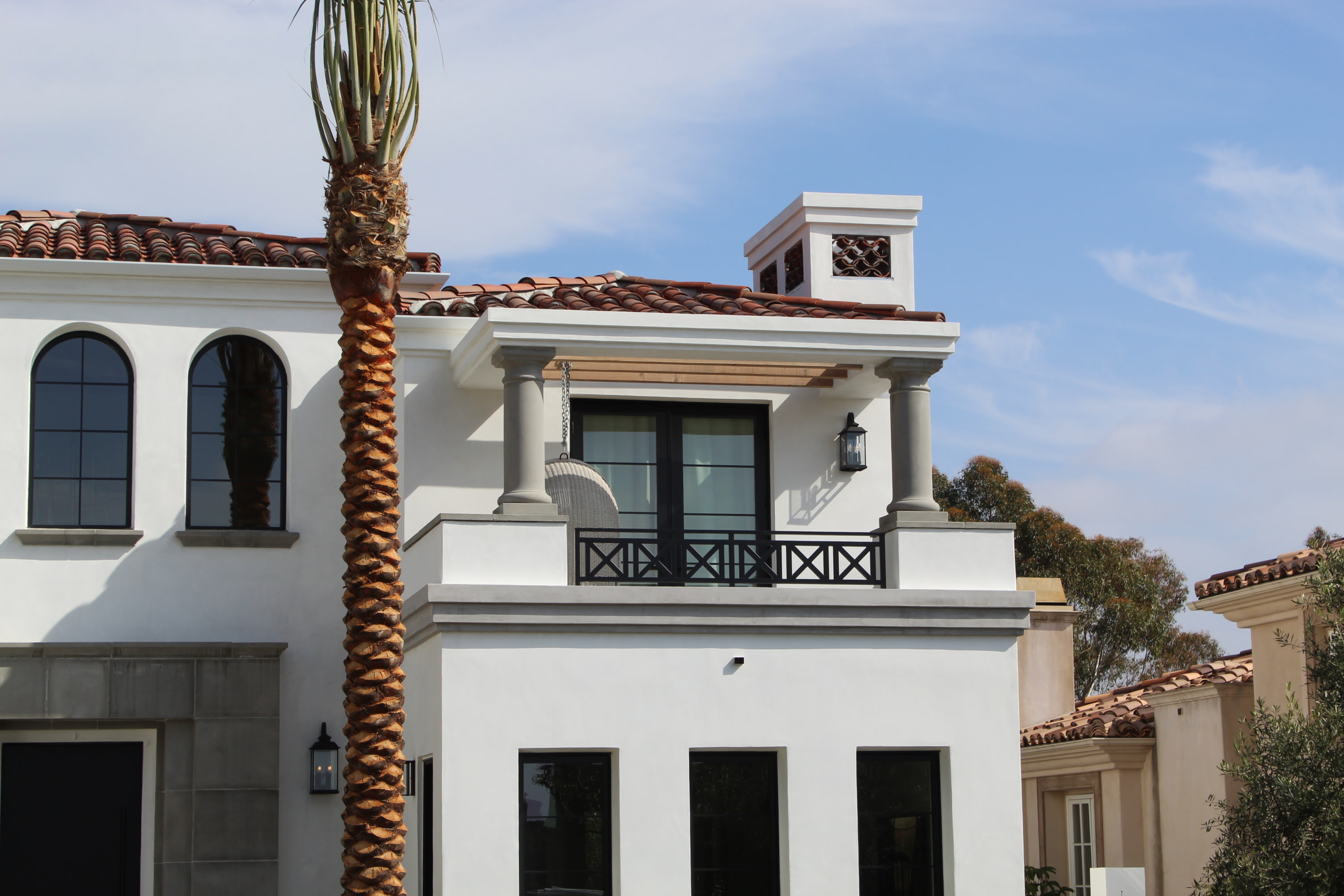 Iron deck railings, precast concrete post, open wood beams