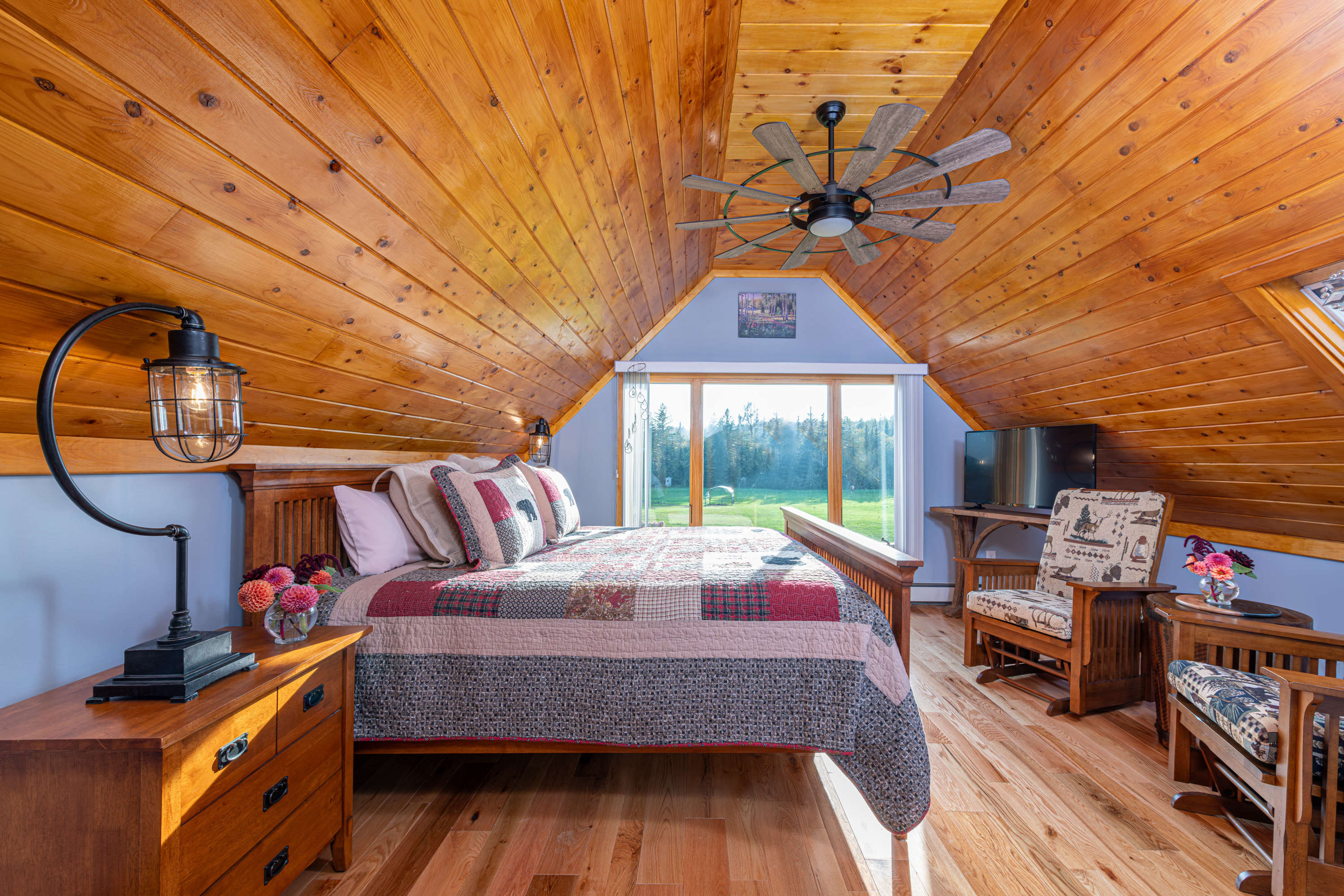 White Mountain Bed & Breakfast room with picture window, king bed, glider rockers, and tv
