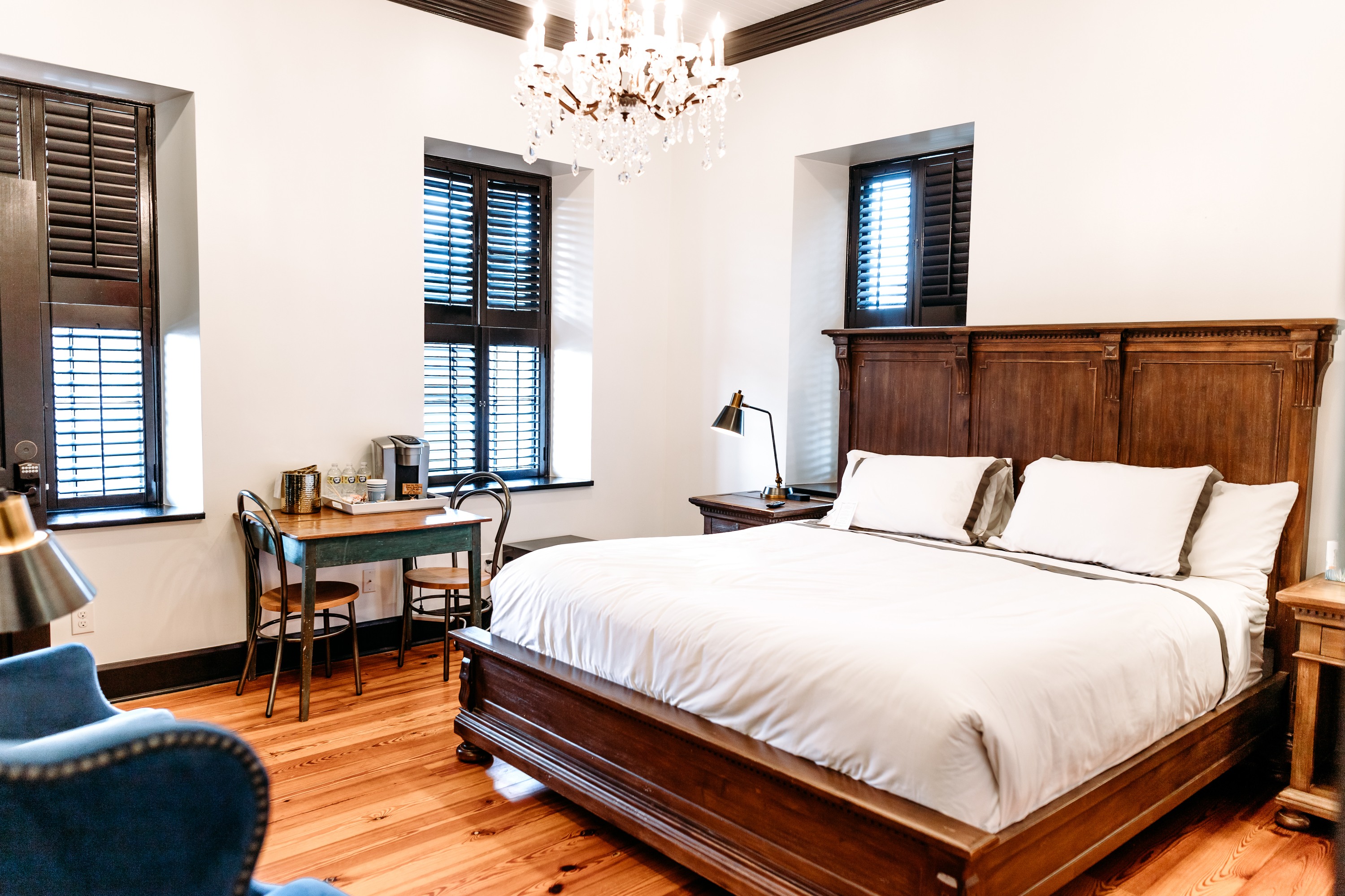 bedroom with king bed, table with coffee bar