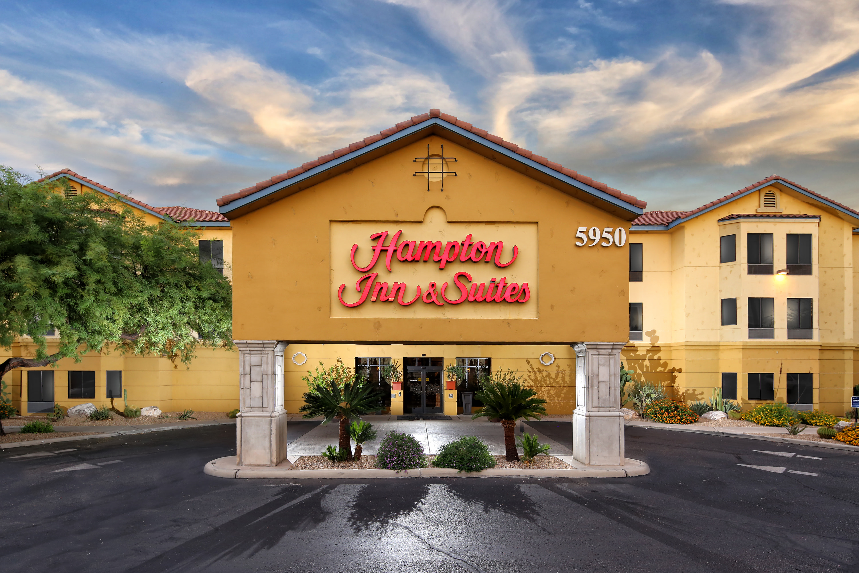 Exterior of Hampton Inn & Suites Tucson Mall with desert landscaping.