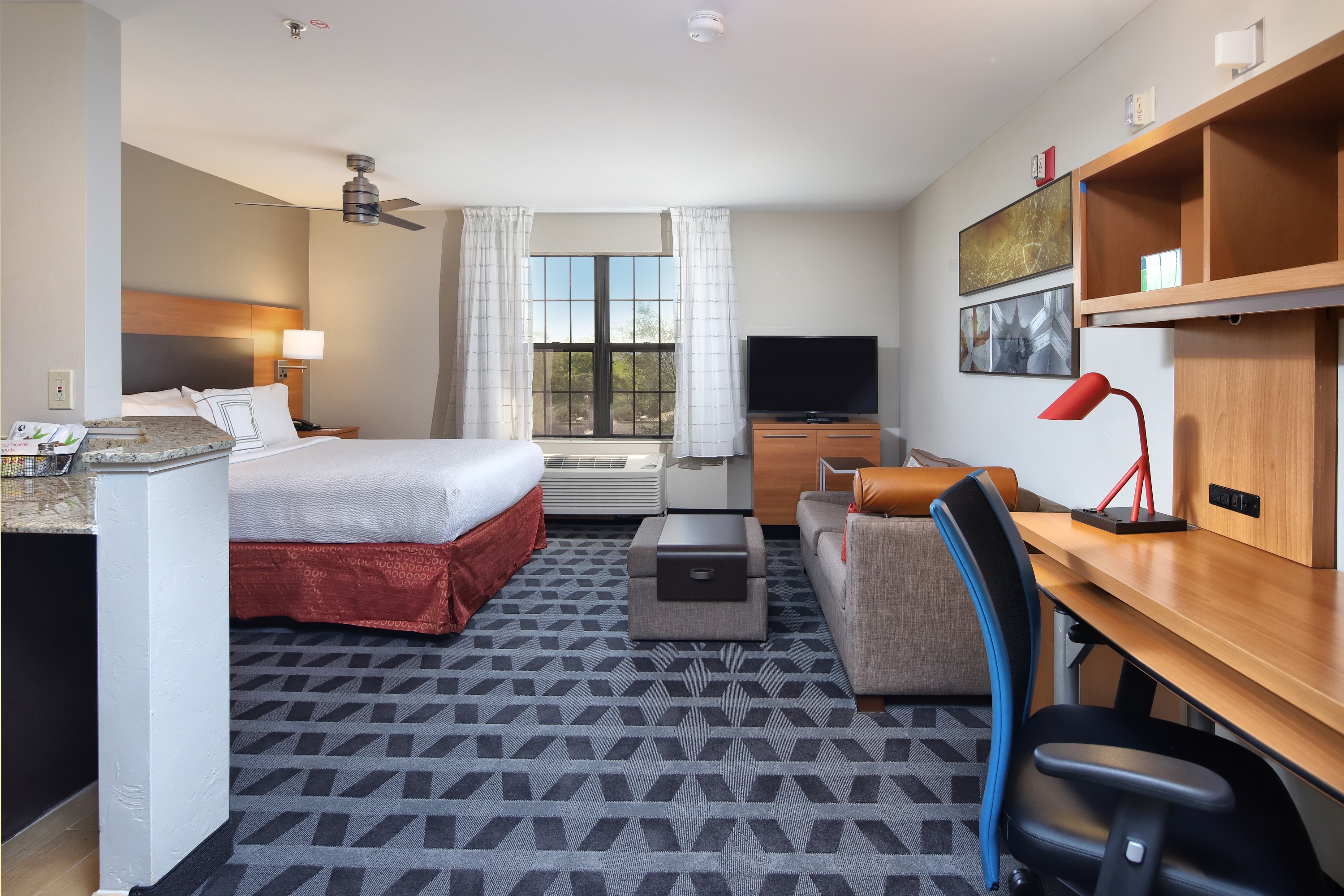 Studio suite at TownePlace Suites Tucson with full kitchen, bed, and seating area.