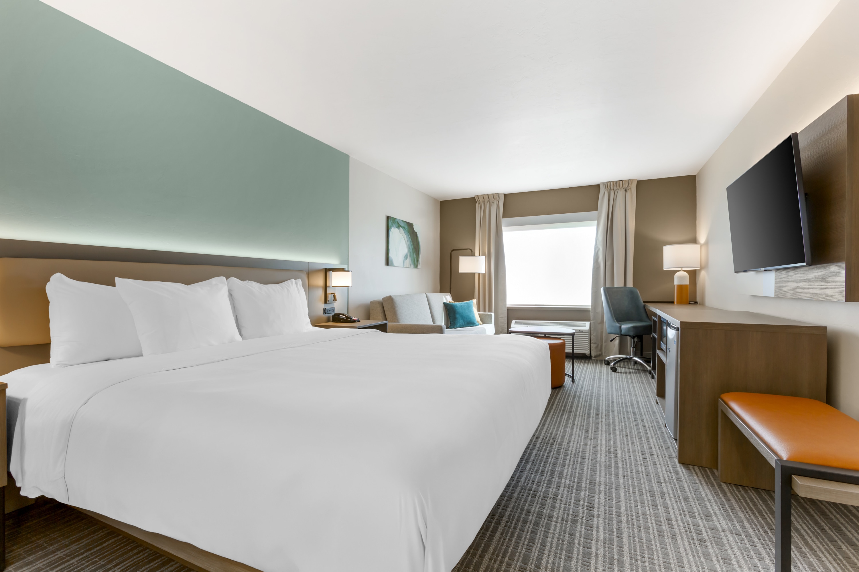 Comfort Suites Tucson Mall one bedroom suite with living area, bedroom, and modern furnishings