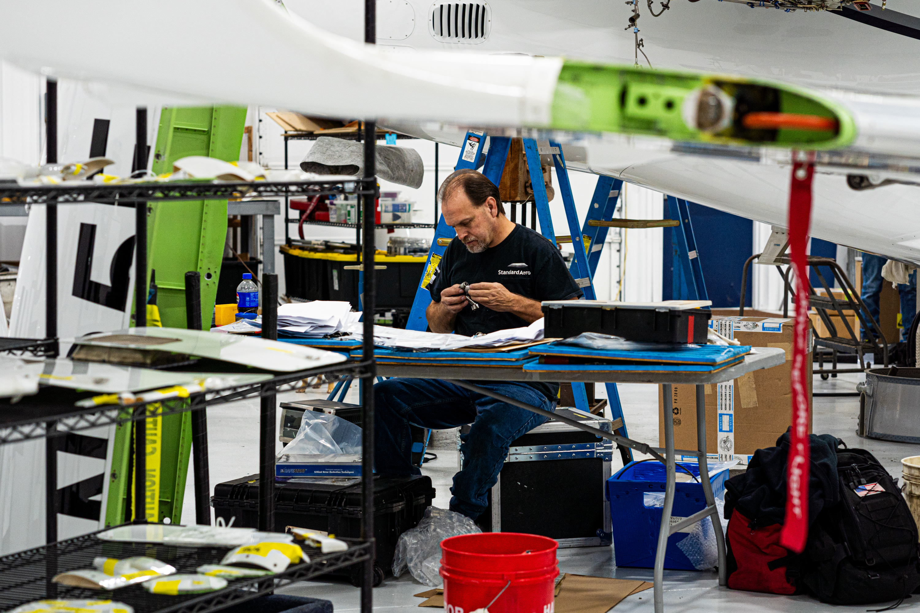 Maintenance worker working on parts to one of the Cirrus planes
