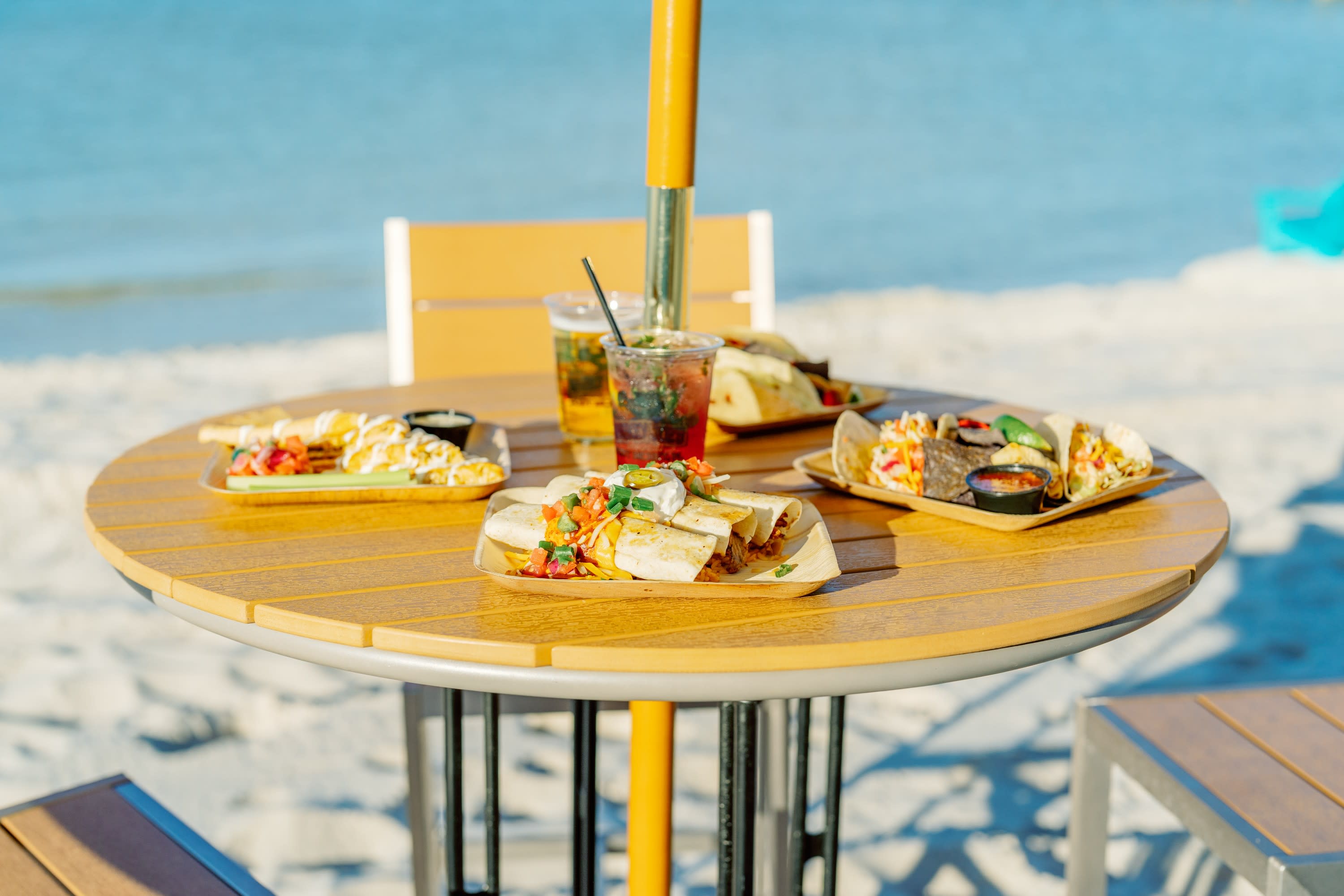 food sitting on table with ocean behind