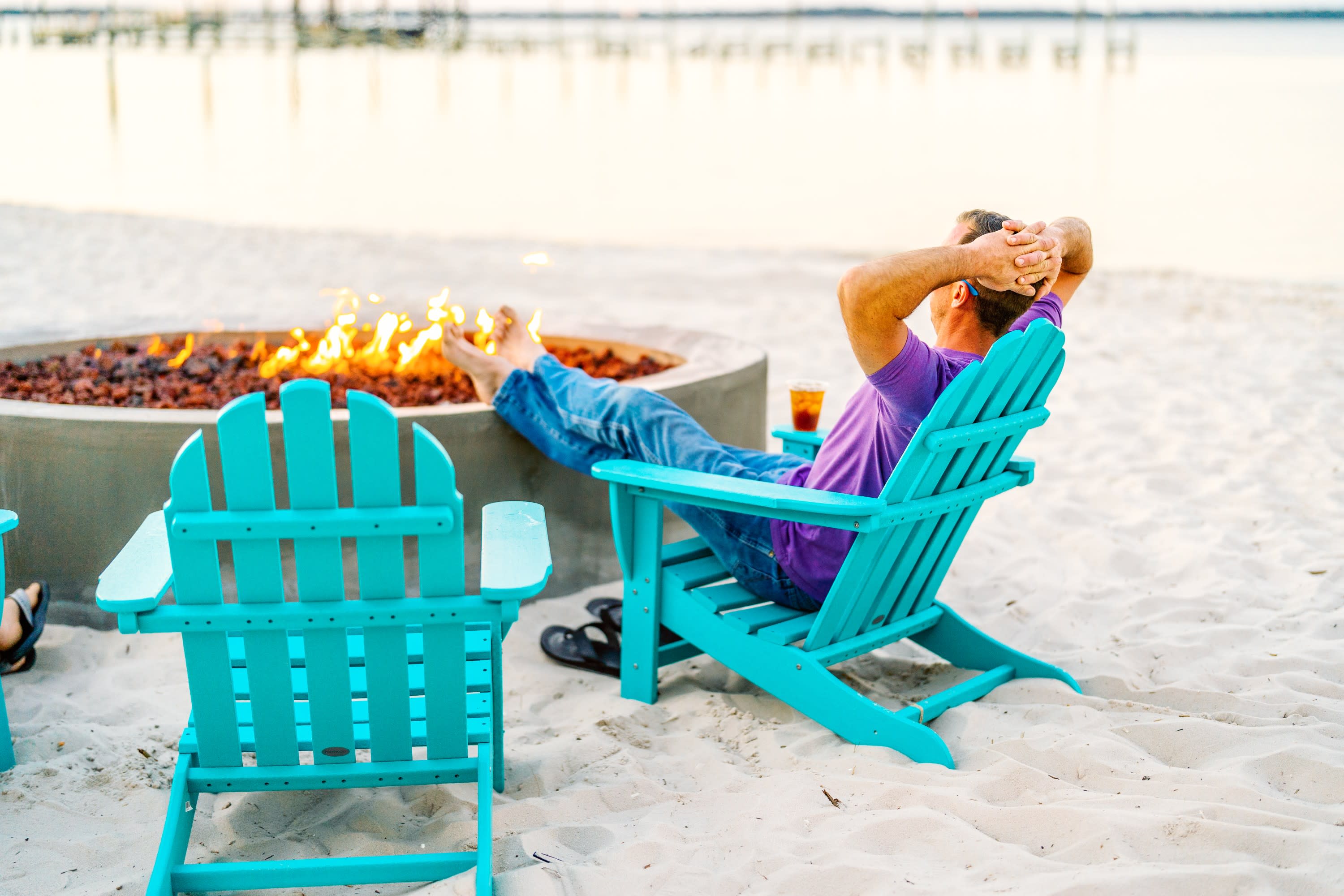 Man sitting next to firepit