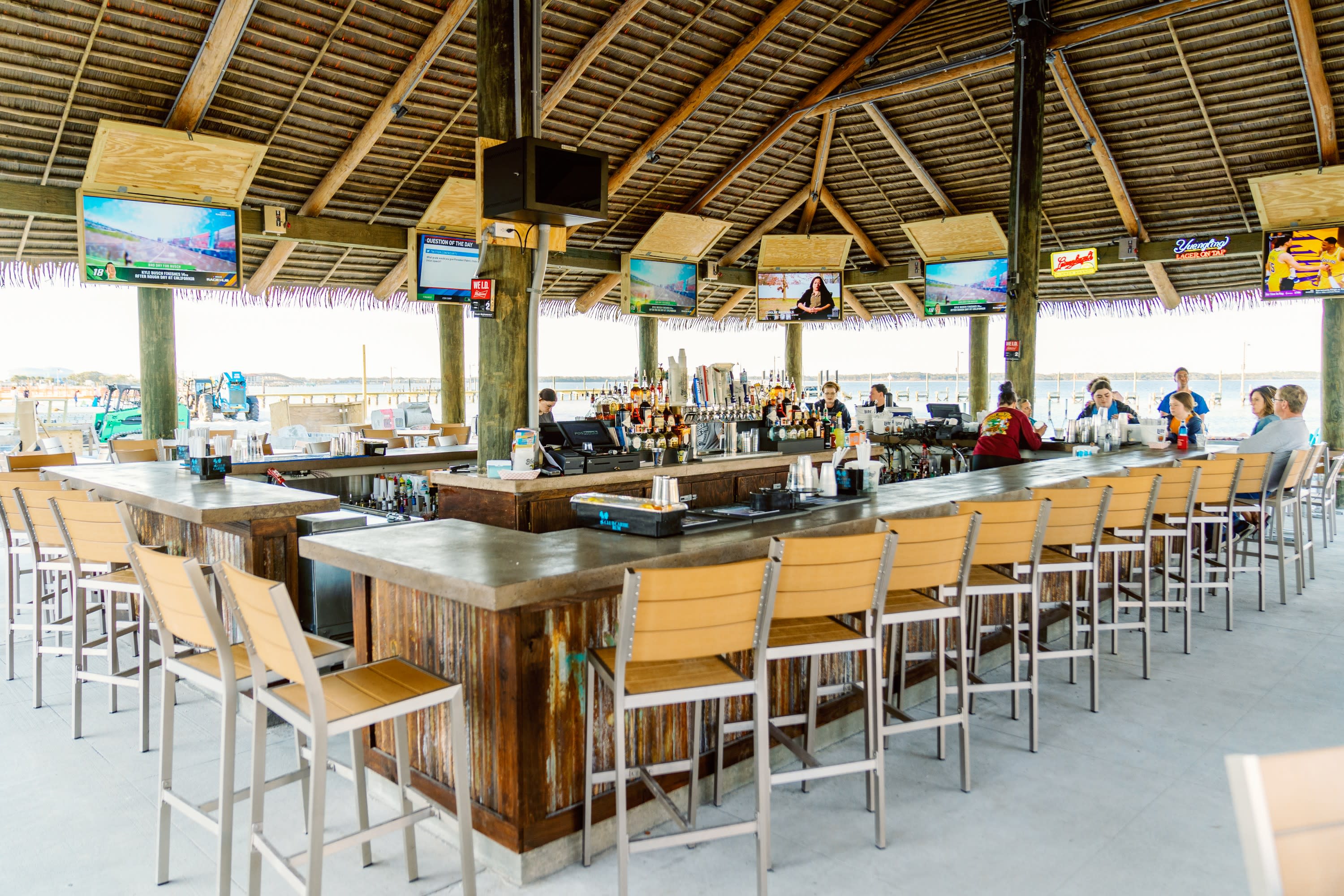 bar top with tvs and chairs