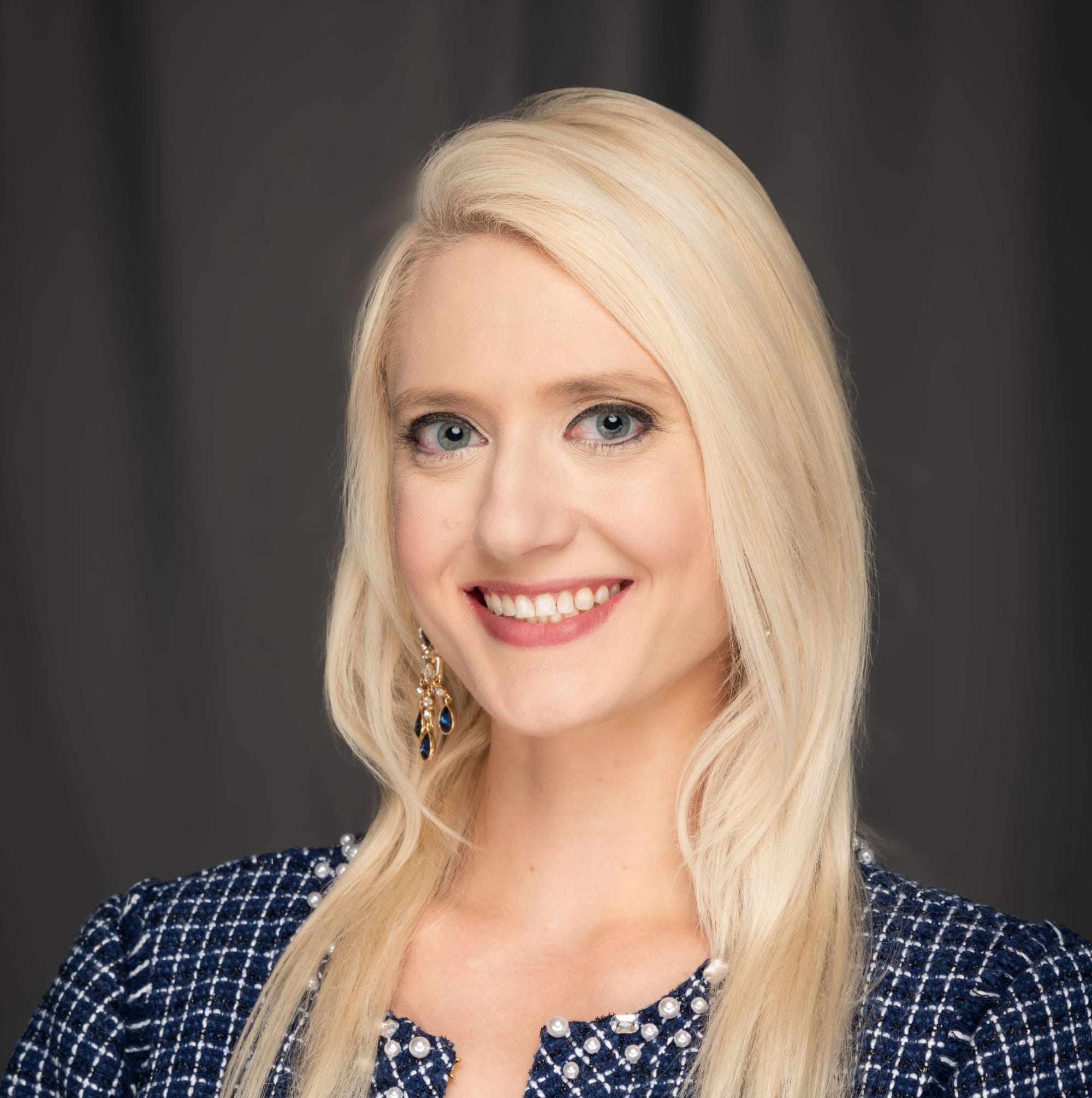 White blond female with a blue blazer