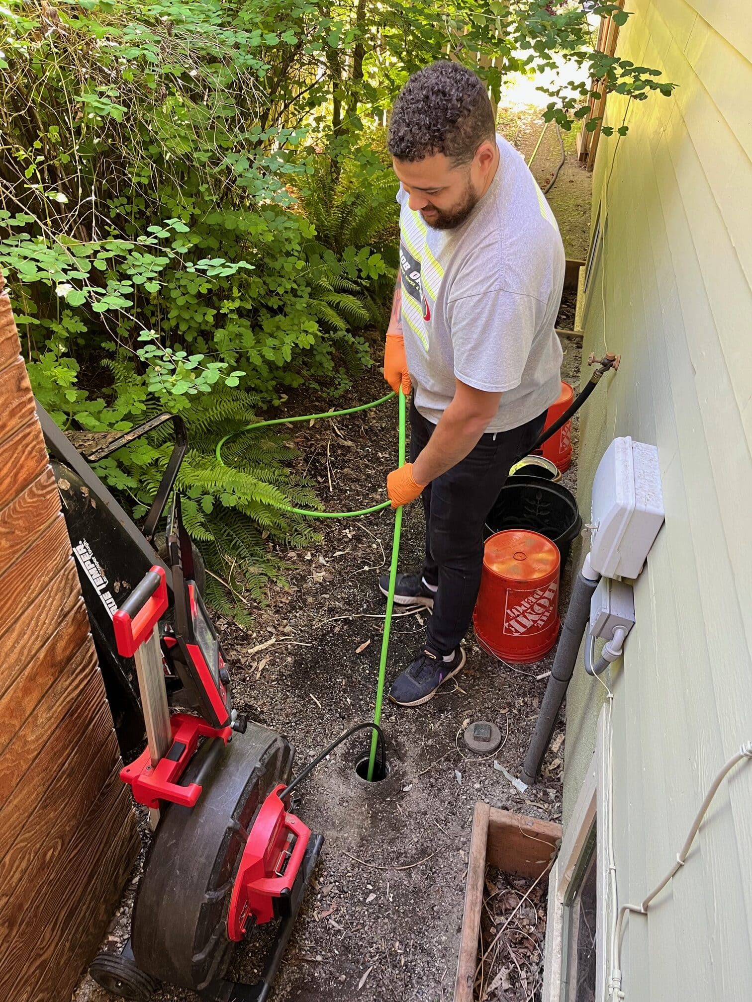 Bob Oates tech hydro jetting a sewer line from an outside cleanout