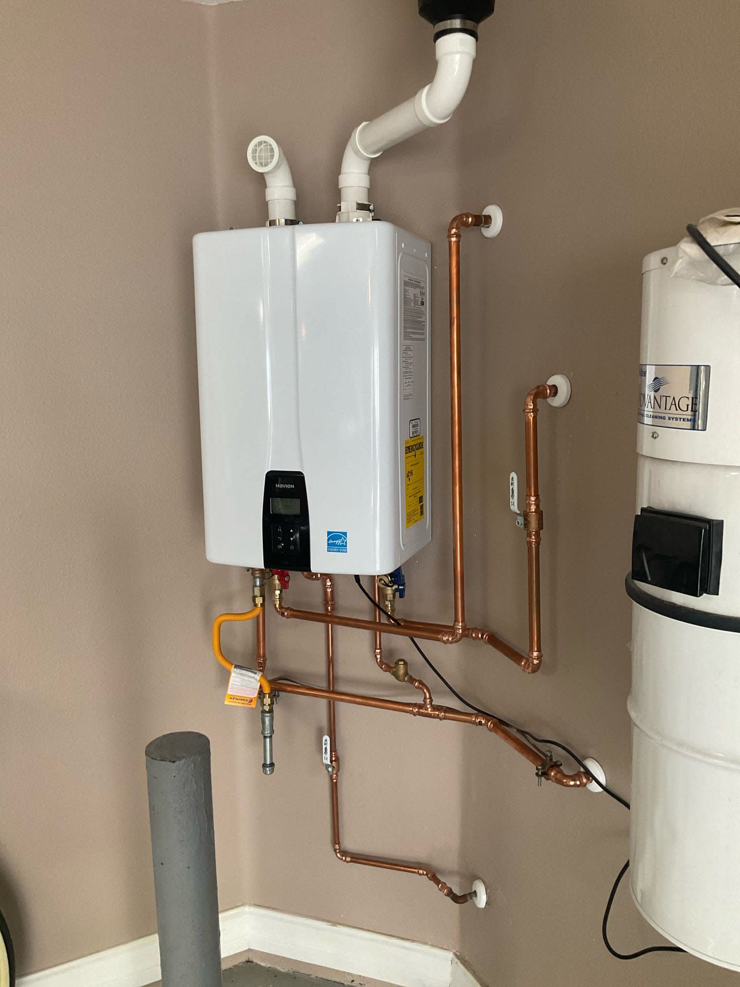 Navien tankless water heater installation replacing a tank unit with new venting and copper piping in a St. Petersburg home
