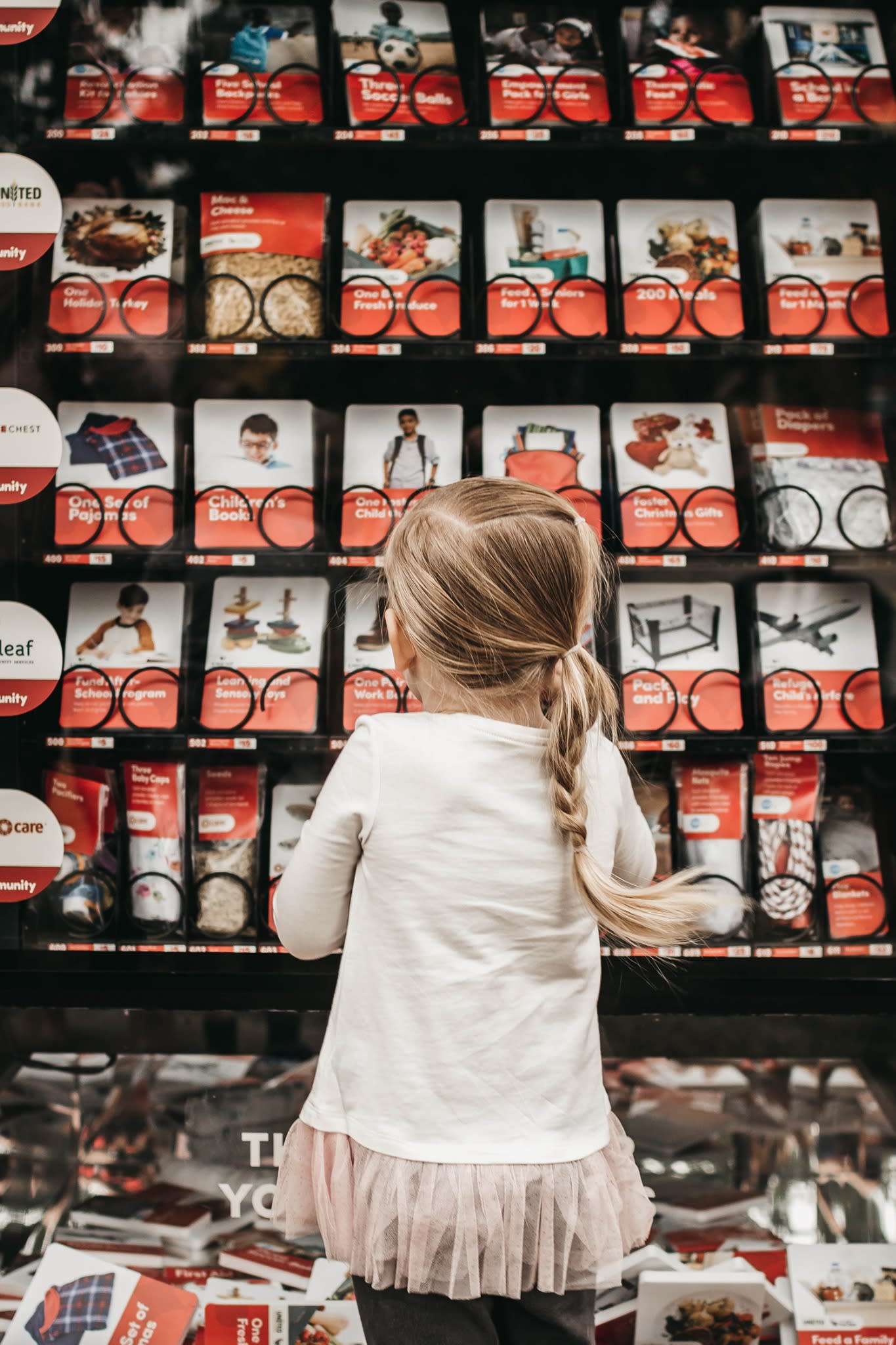 Child making donation at Giving Machine