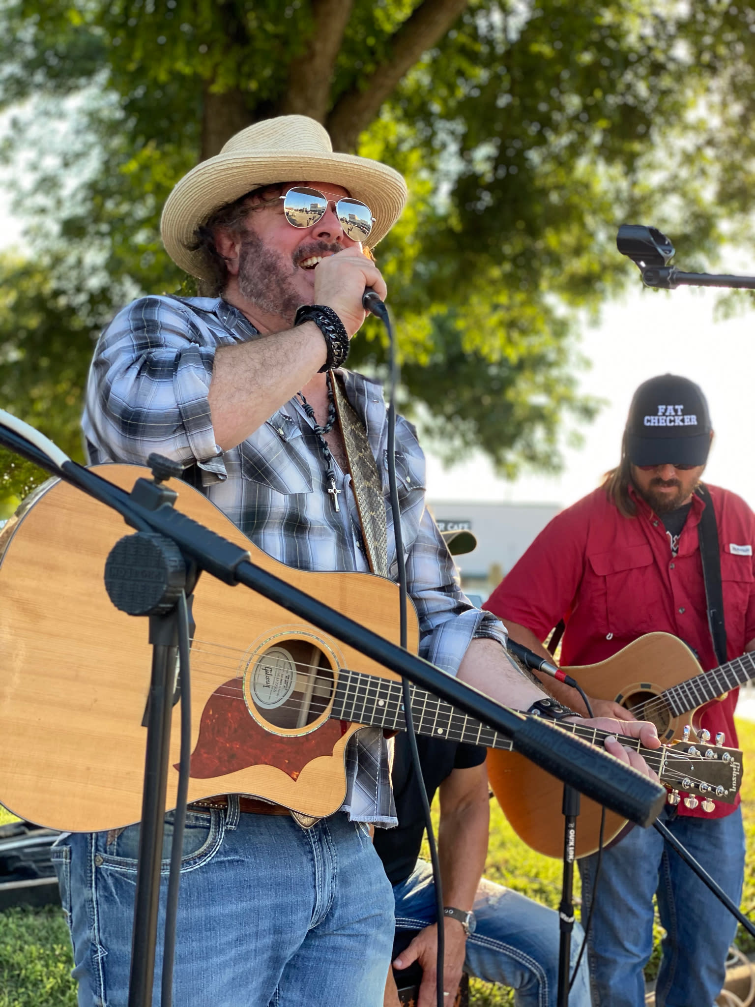 musician singing holding guitar