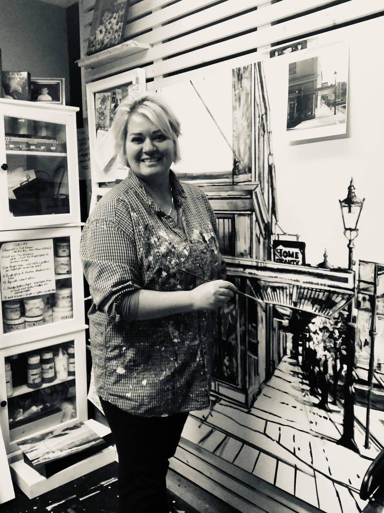 an image of theresa eisenbarth painting a Medicine Hat corner, street scene in her studio