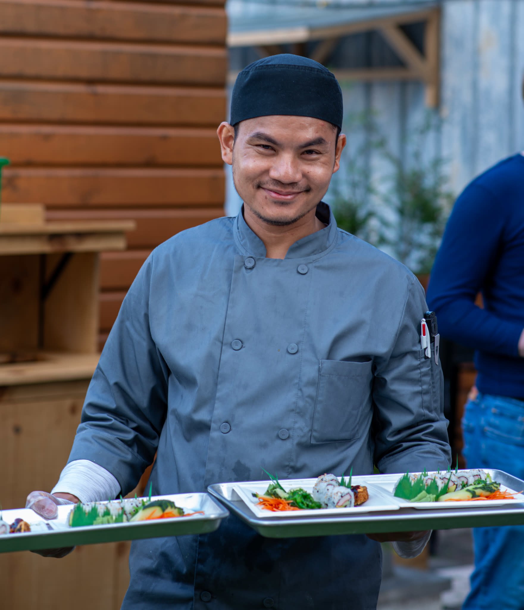 Local Chef holdng food served on the International Food Tour