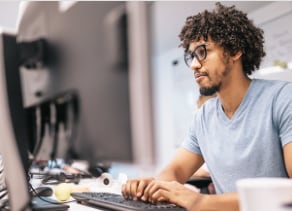 Man typing at a computer