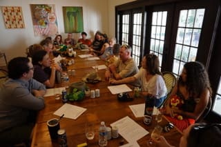 people at long table in a learning retreat