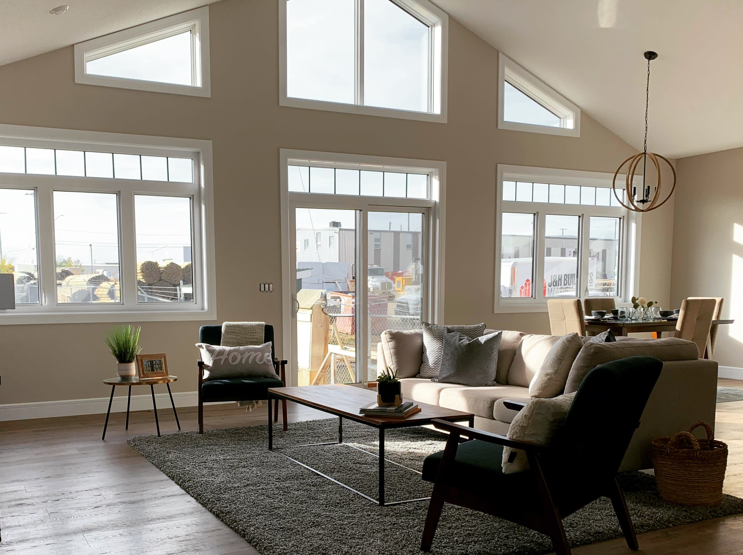 Floor to ceiling windows in Living Room with Vaulted Ceiling