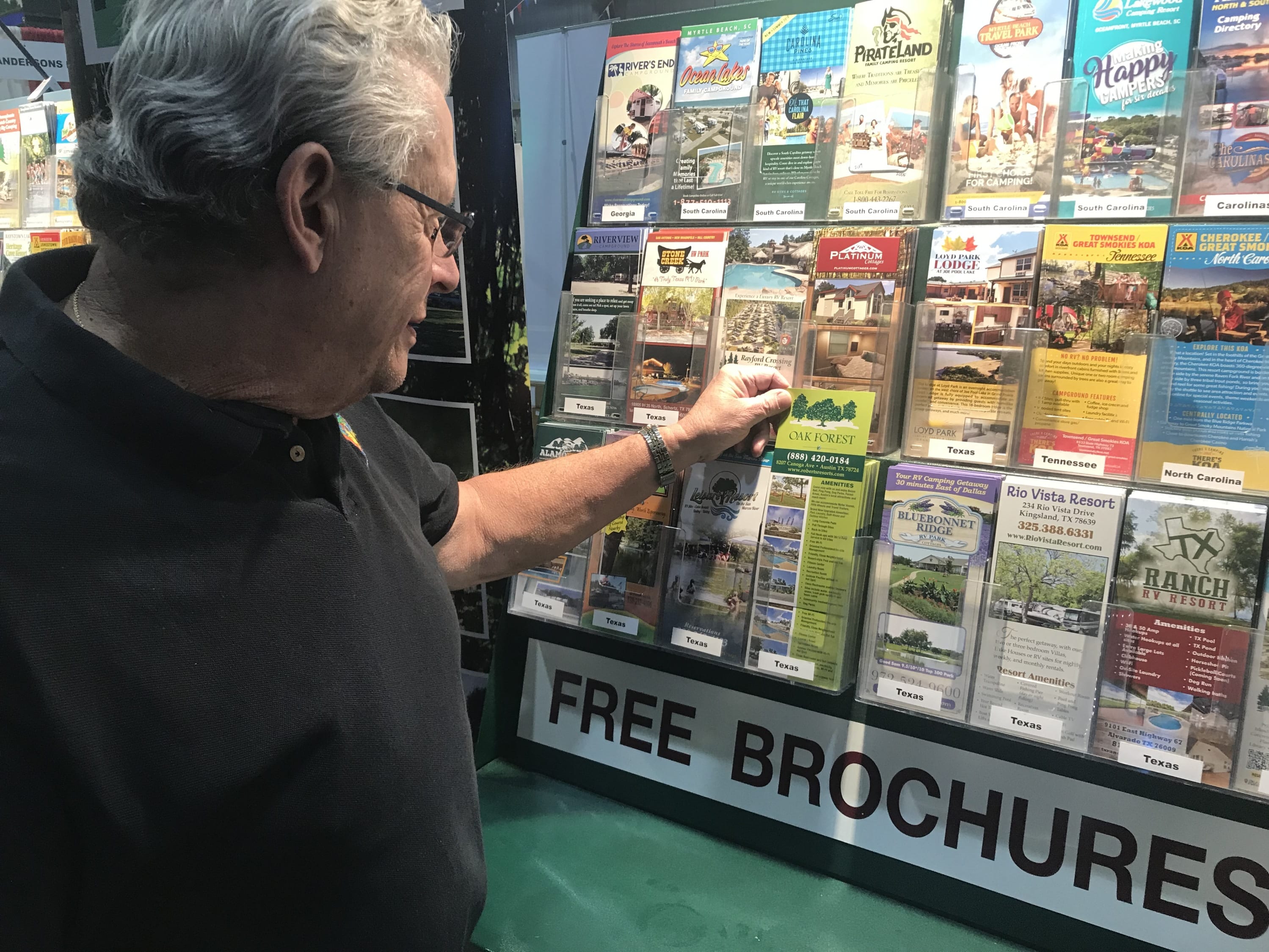 Man selects brochure from display