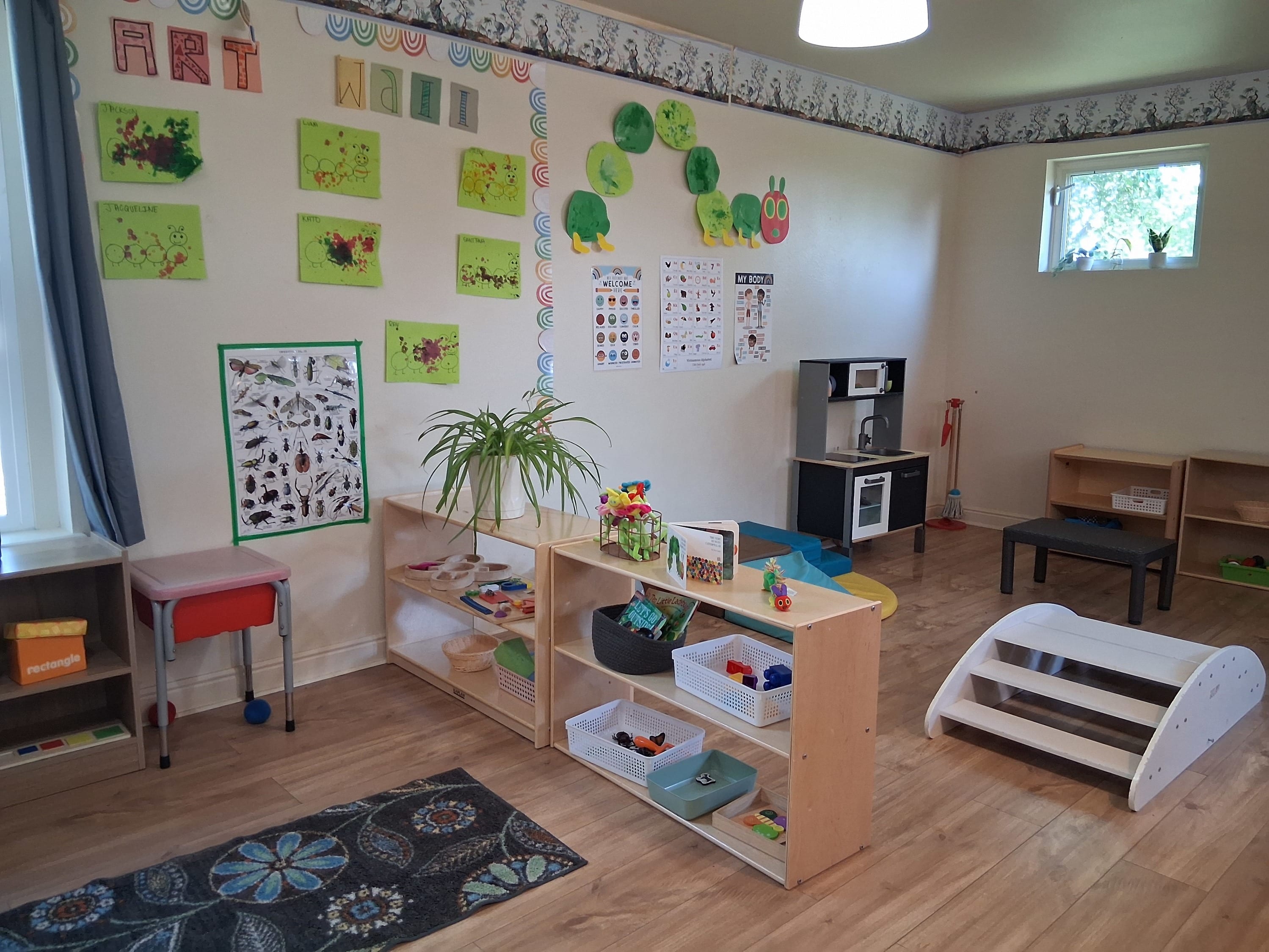 A toddler classroom with various materials and climbing equipment