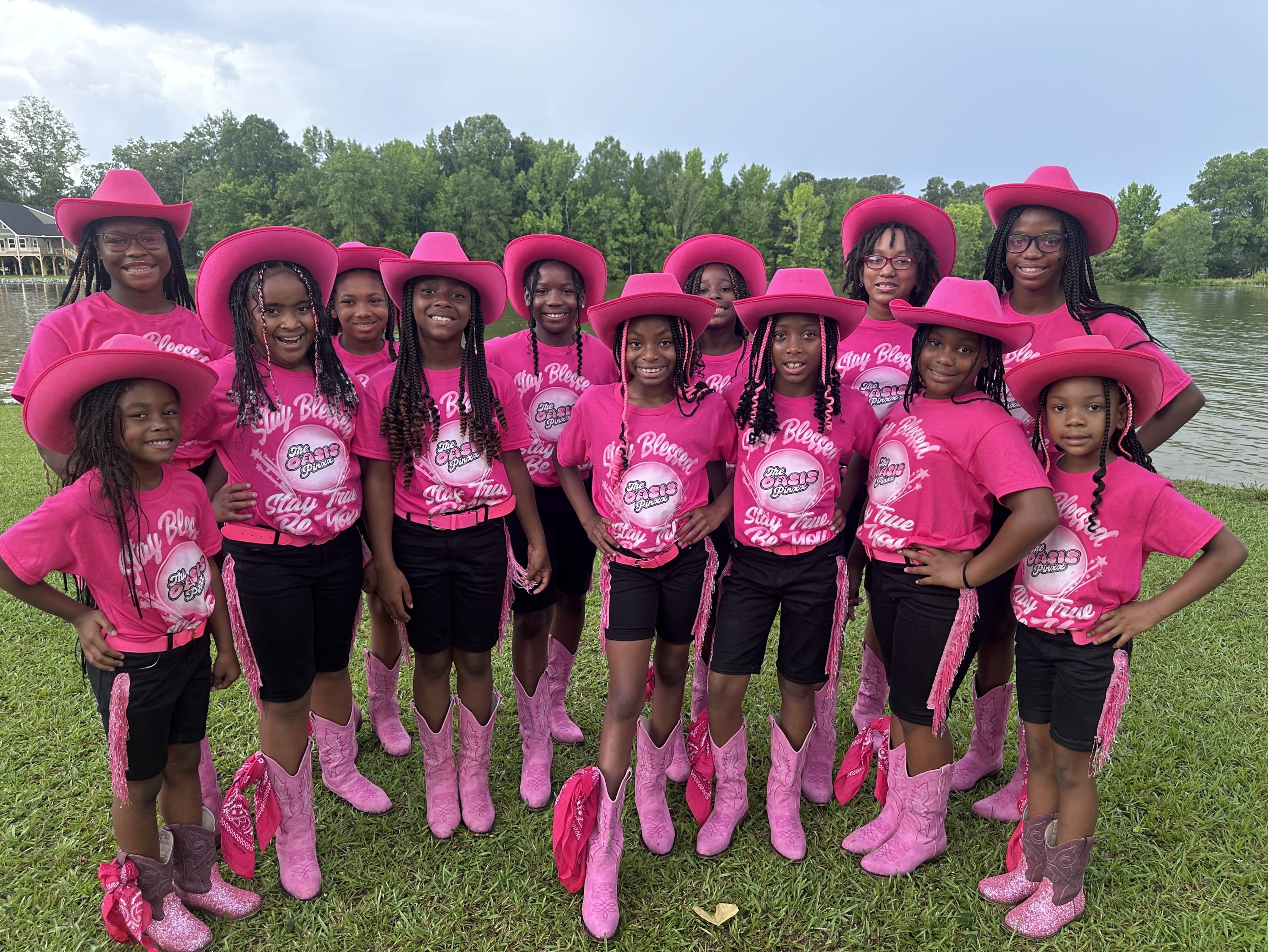 The Oasis Pinxx youth dance team in pink uniforms and cowgirl hats