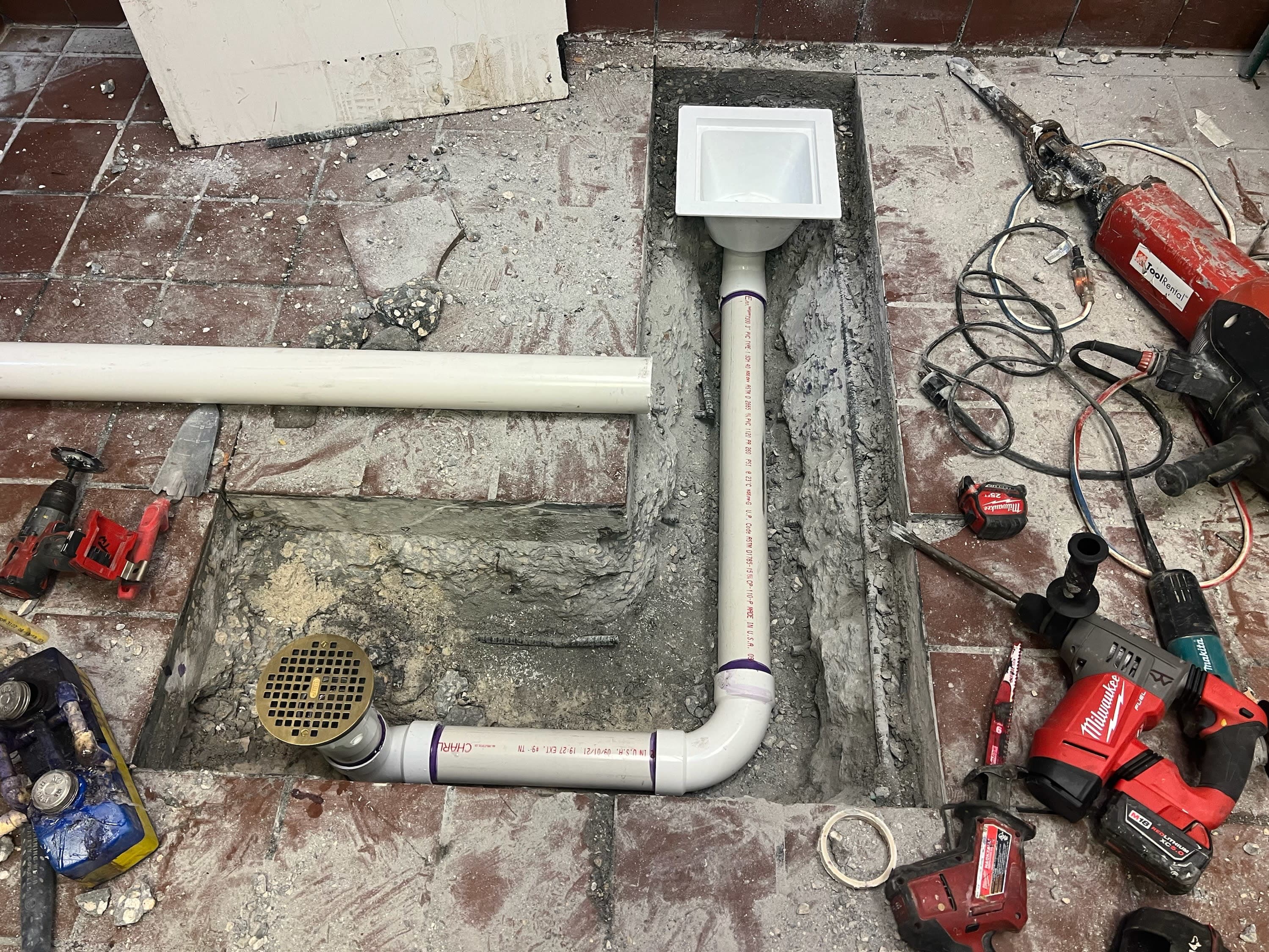 Commercial floor sink and floor drain replacement under slab in a St. Petersburg restaurant kitchen