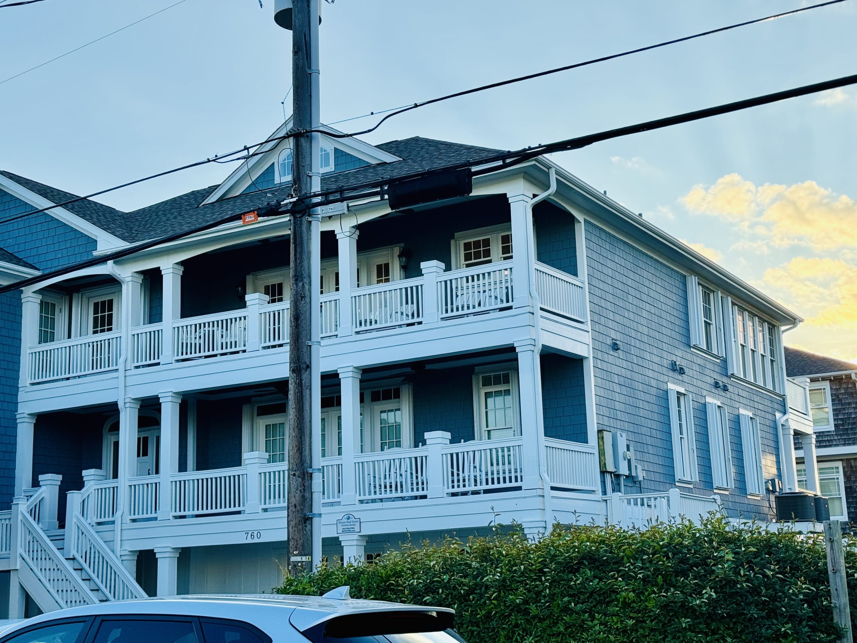 White accordion shutters on a blue beachfront home in Surf City