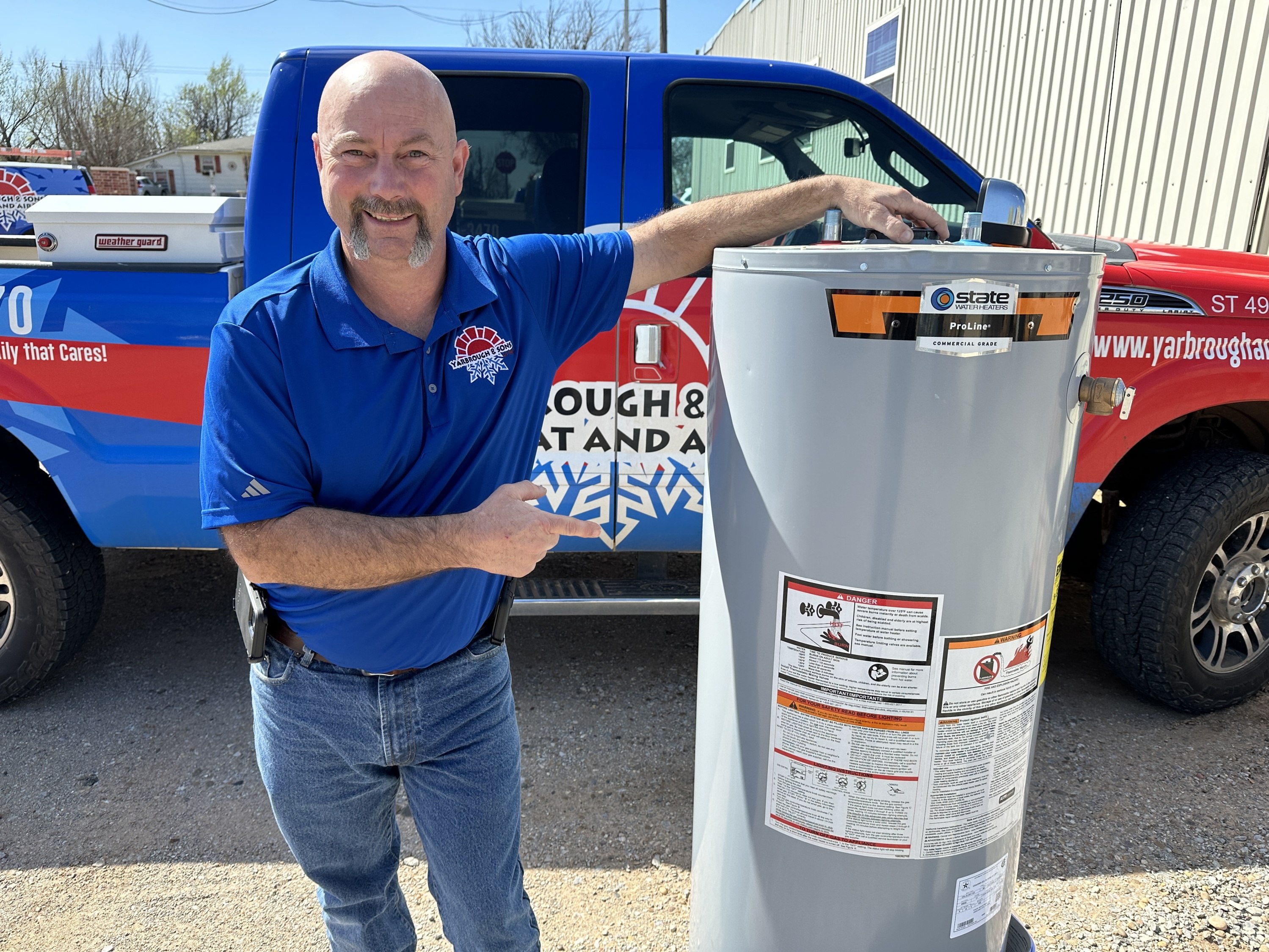 Yarbrough & Sons Plumbing Manager James stands next to a 50 gallon State water heater.