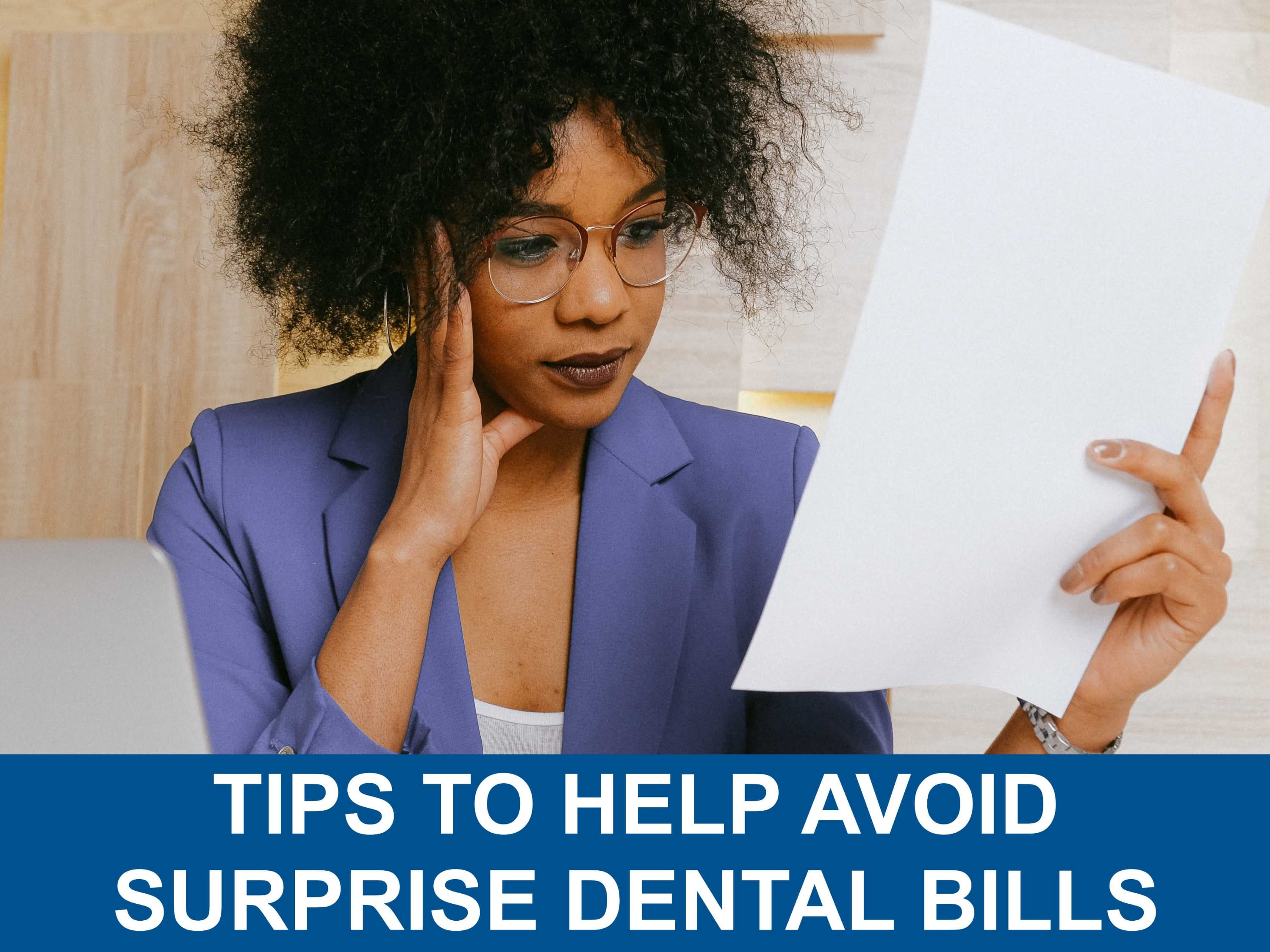 African American woman has a perplexed look on her face as she looks at a surprise dental bill.