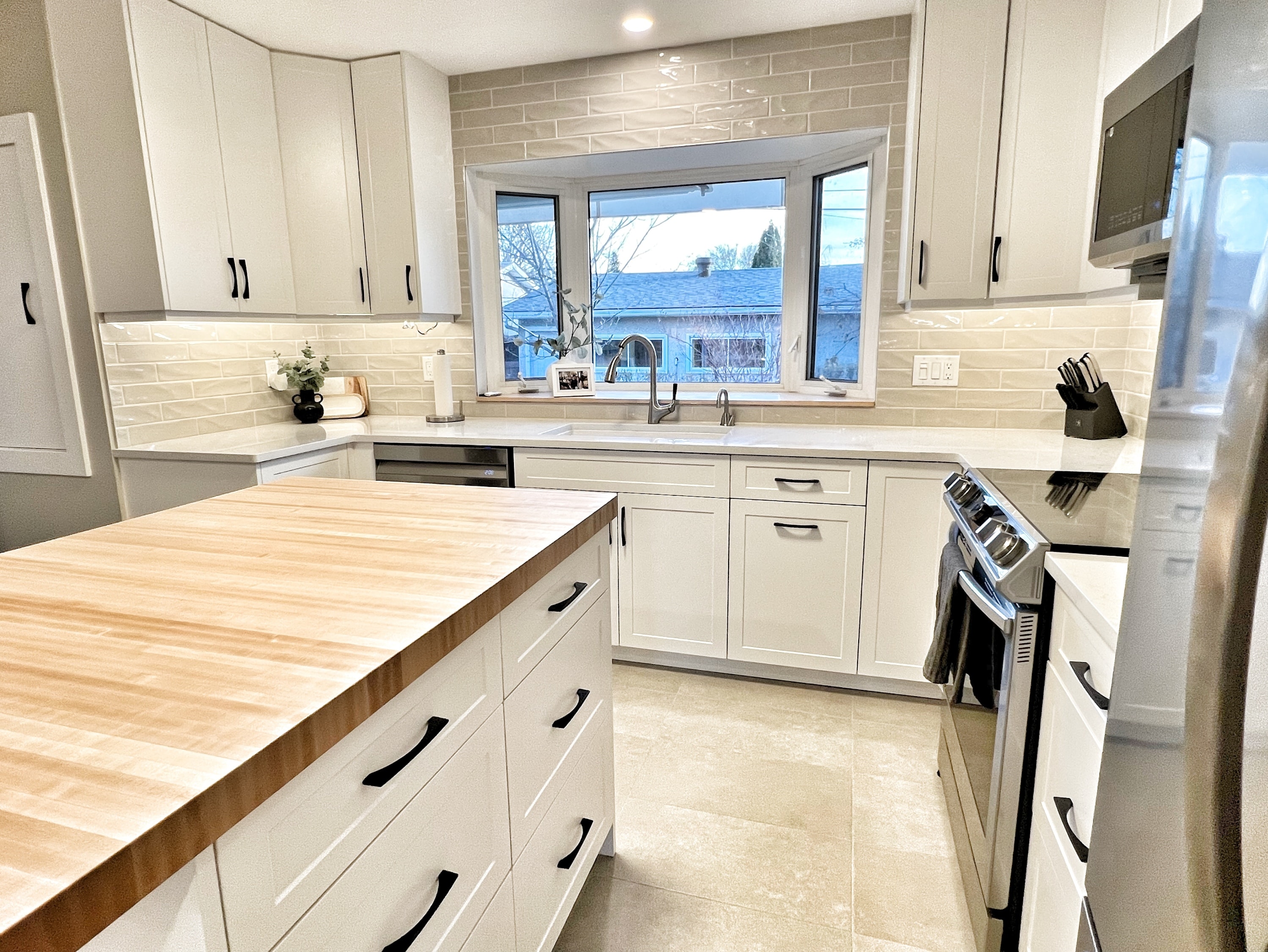 White kitchen, butcher block countertop and backsplash